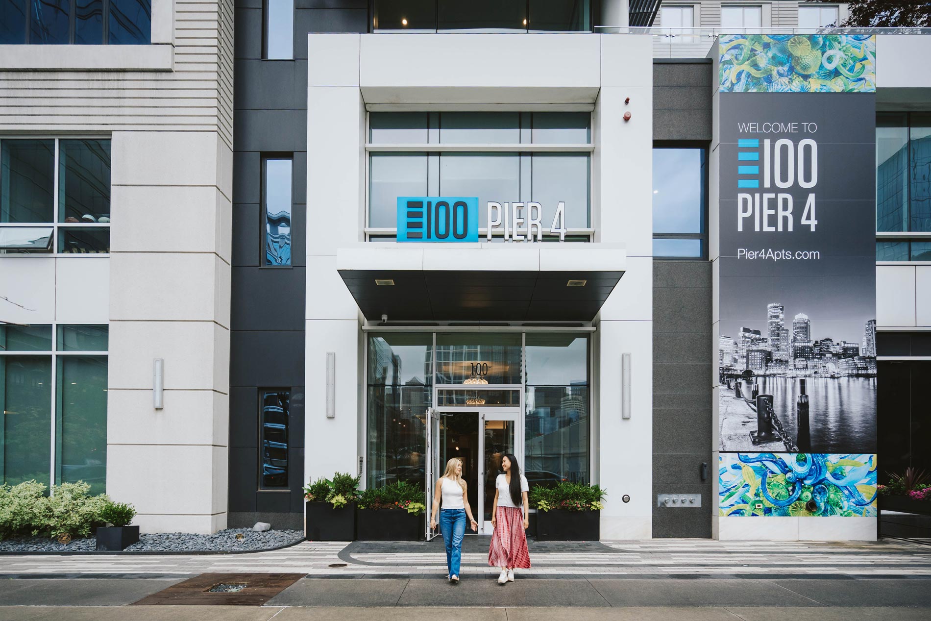 100 Pier 4 two women leave the front of the building