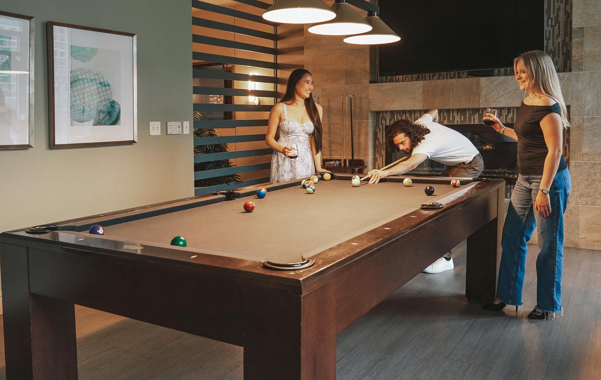 100 Pier 4 three people play pool in the clubhouse