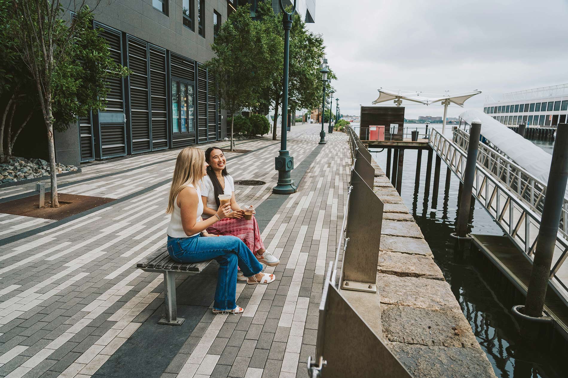 100 Pier 4 two women sit by the pier by the property