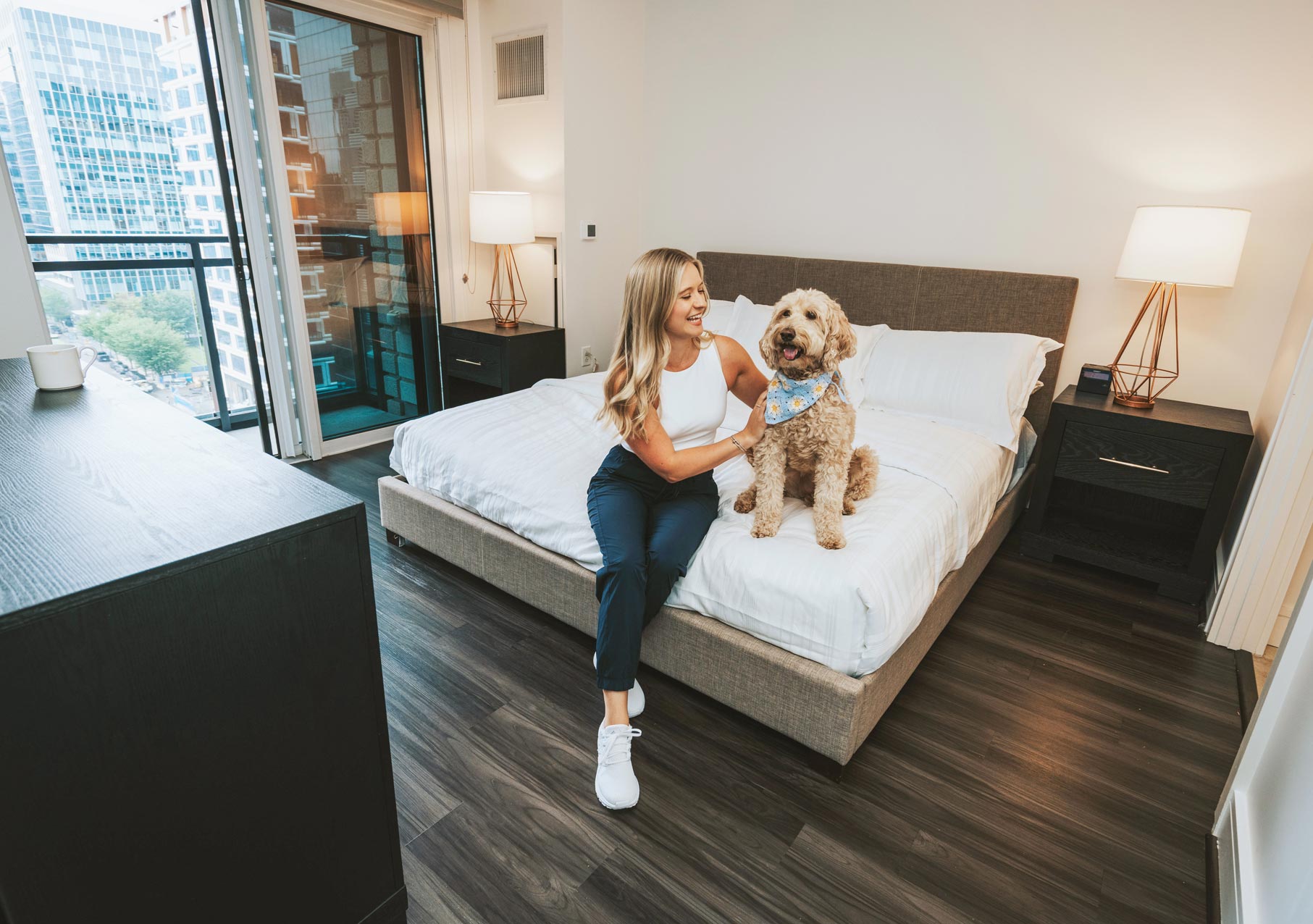 100 Pier 4 man woman sits in bedroom with dog