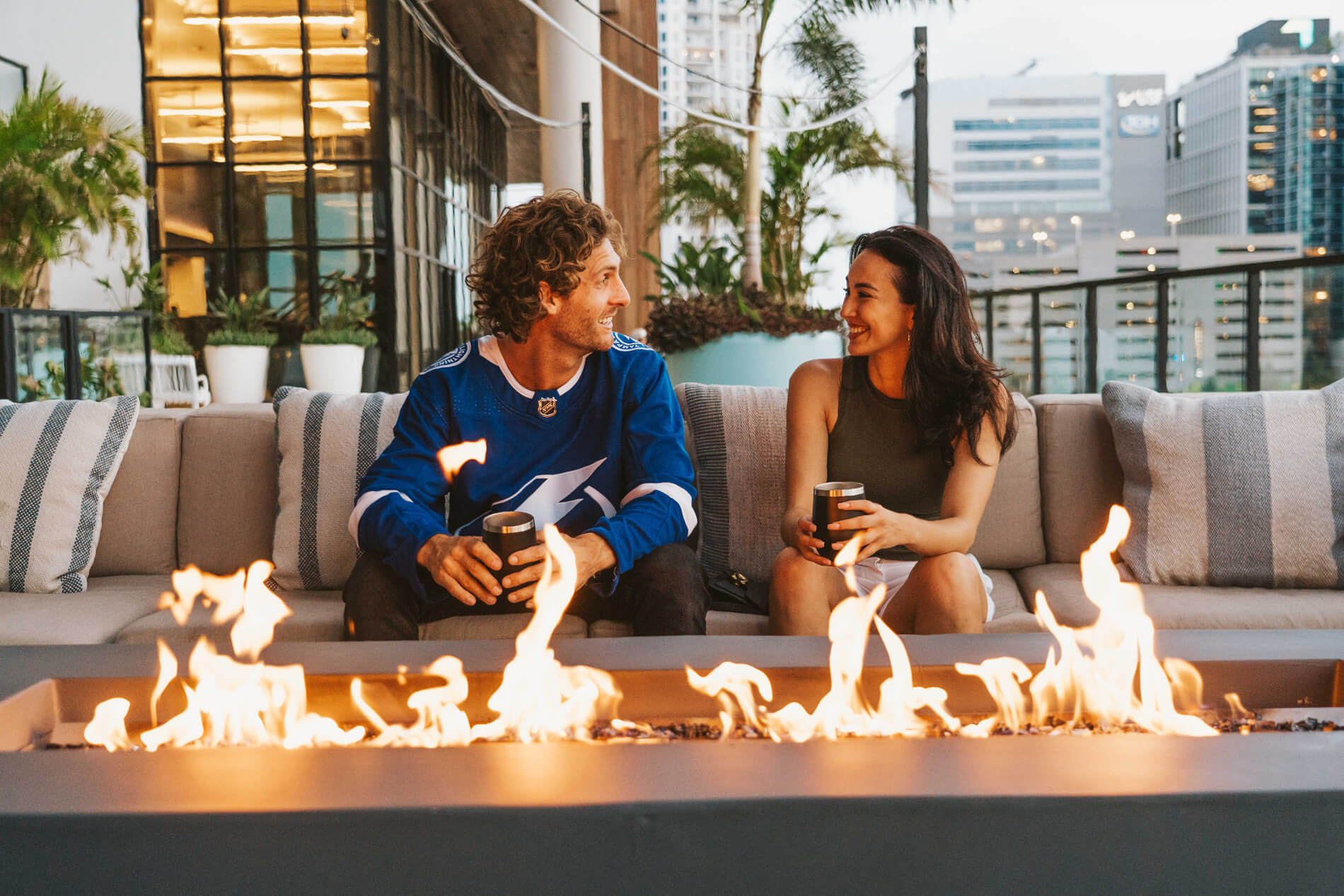 101 N Meridian woman and man sitting by fire on the terrace