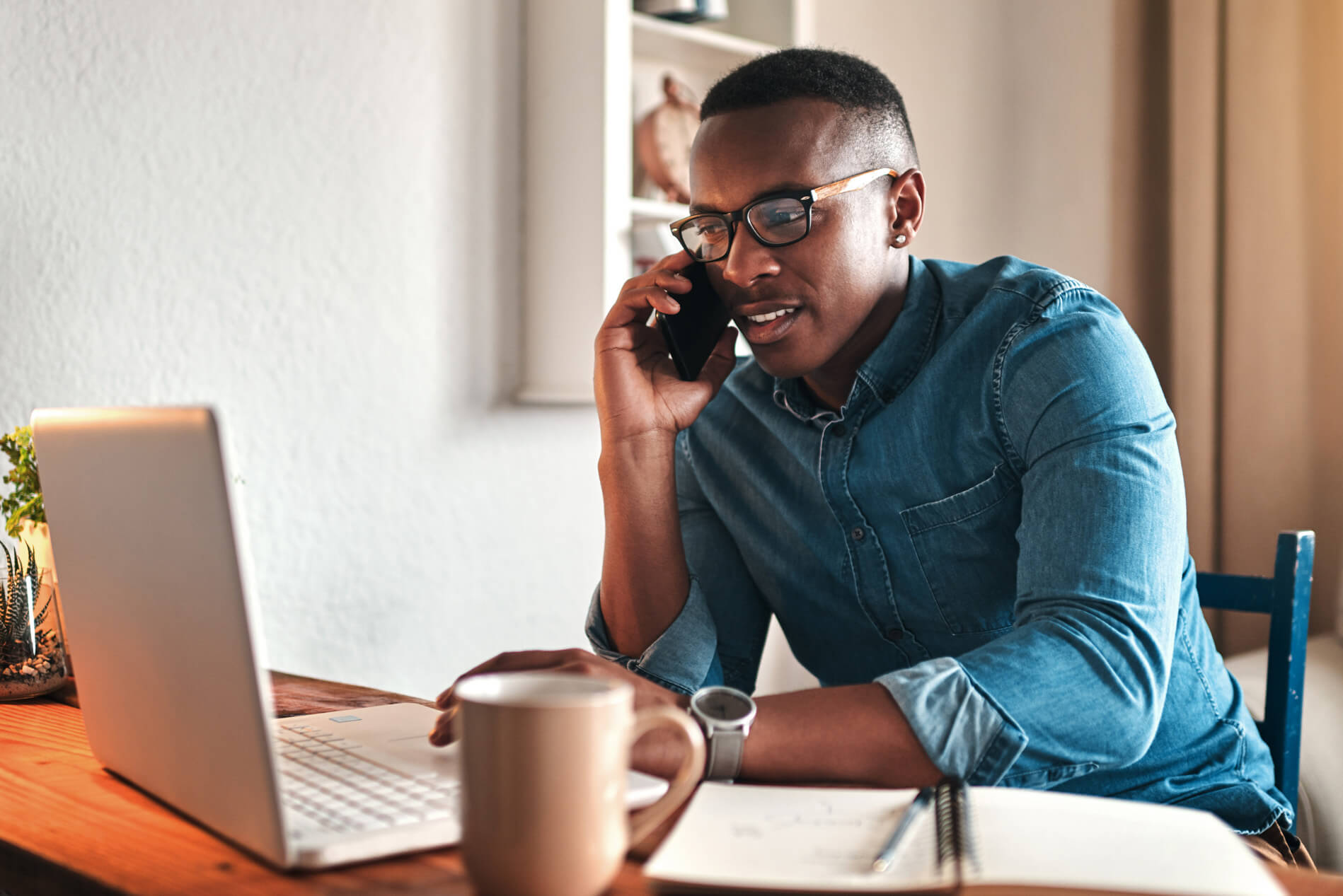 Man on the phone at the computer