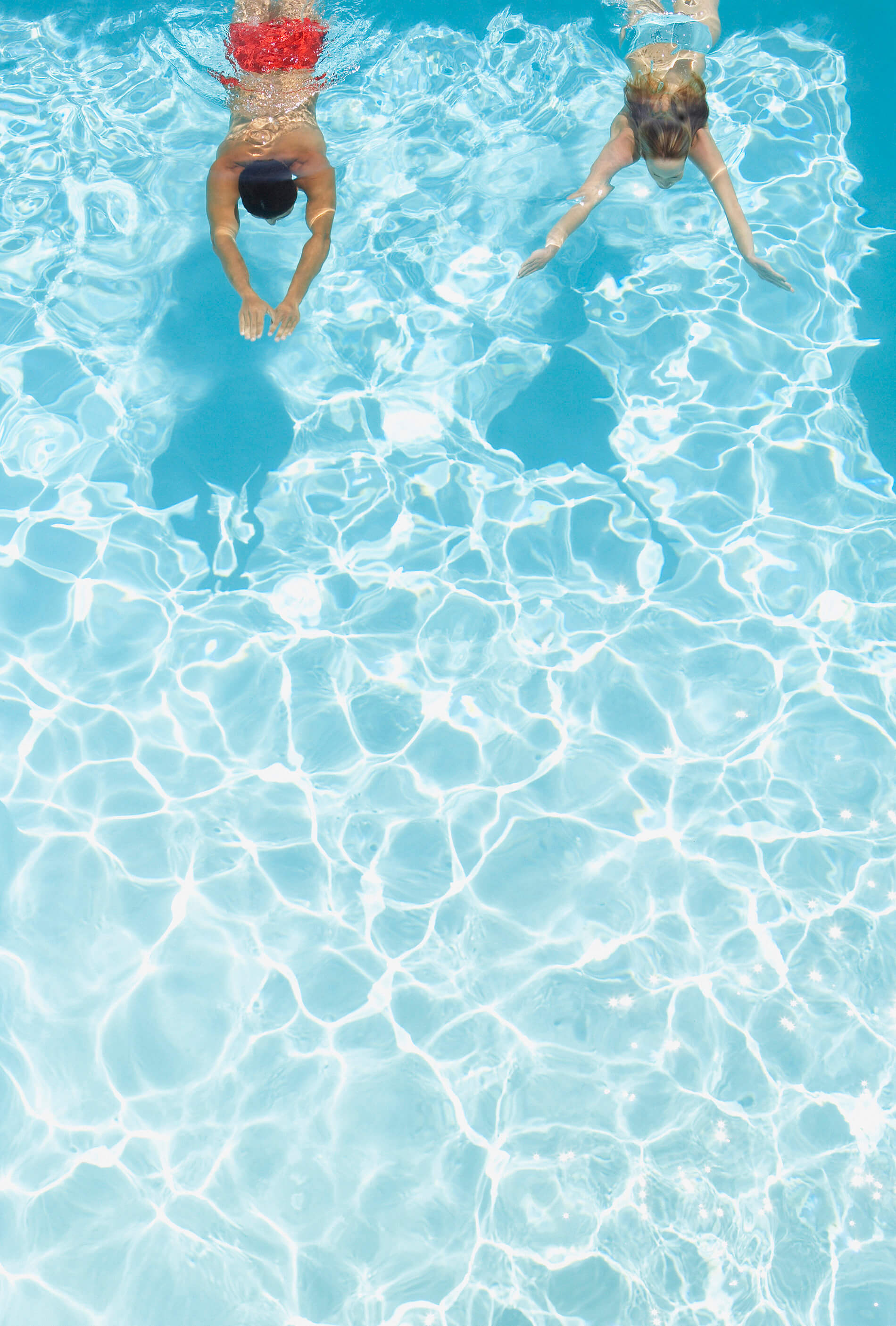 Two people swimming in pool