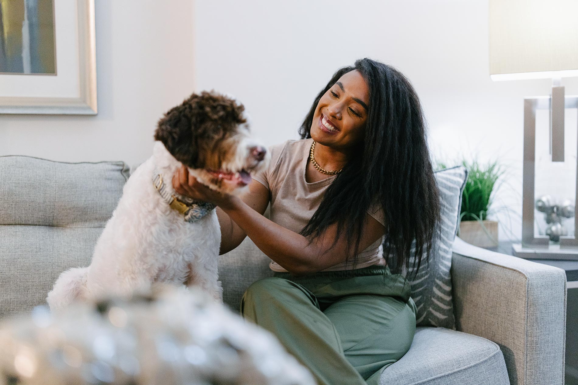 Andover House woman sits on couch with dog