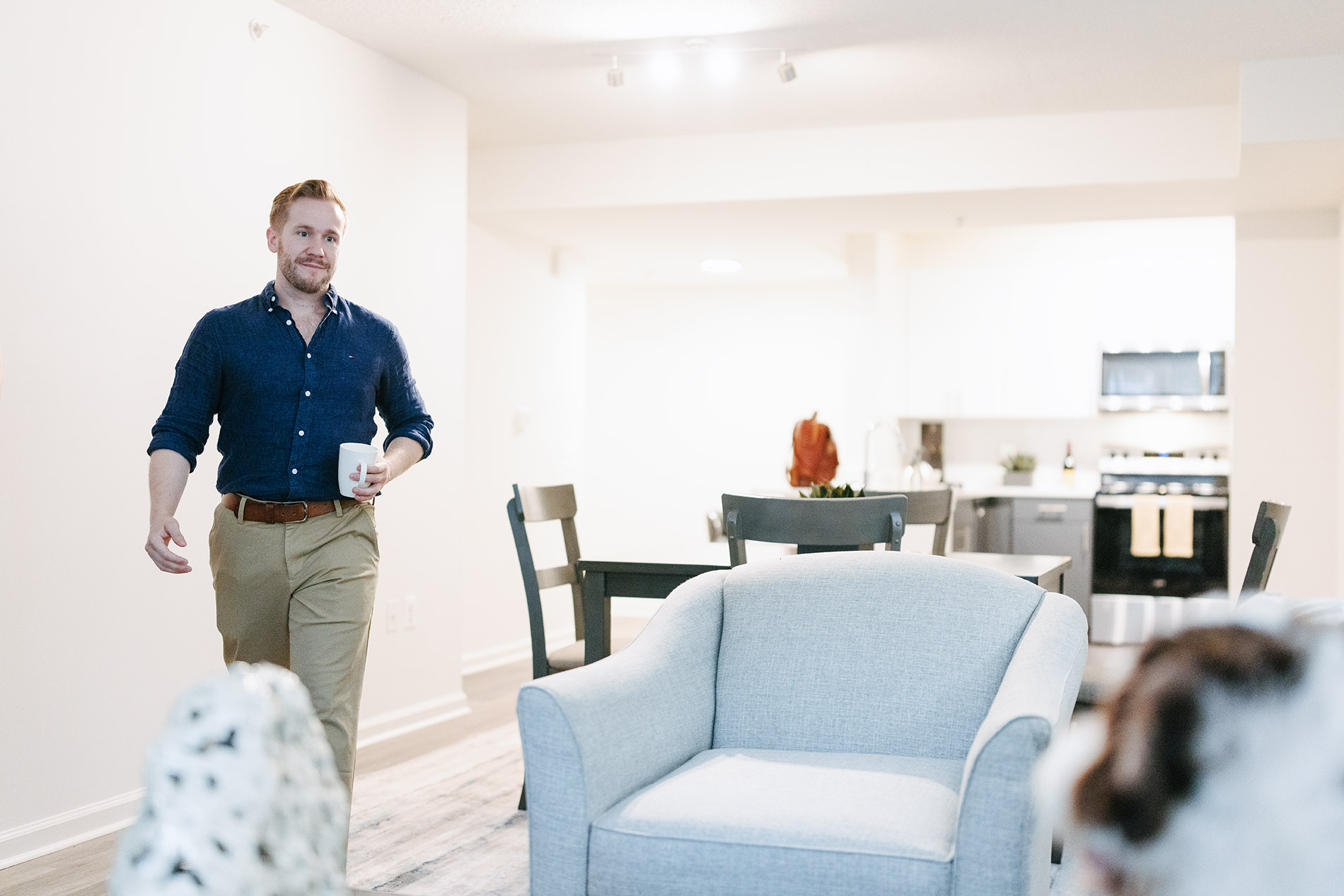 Andover House man walks from kitchen with coffee