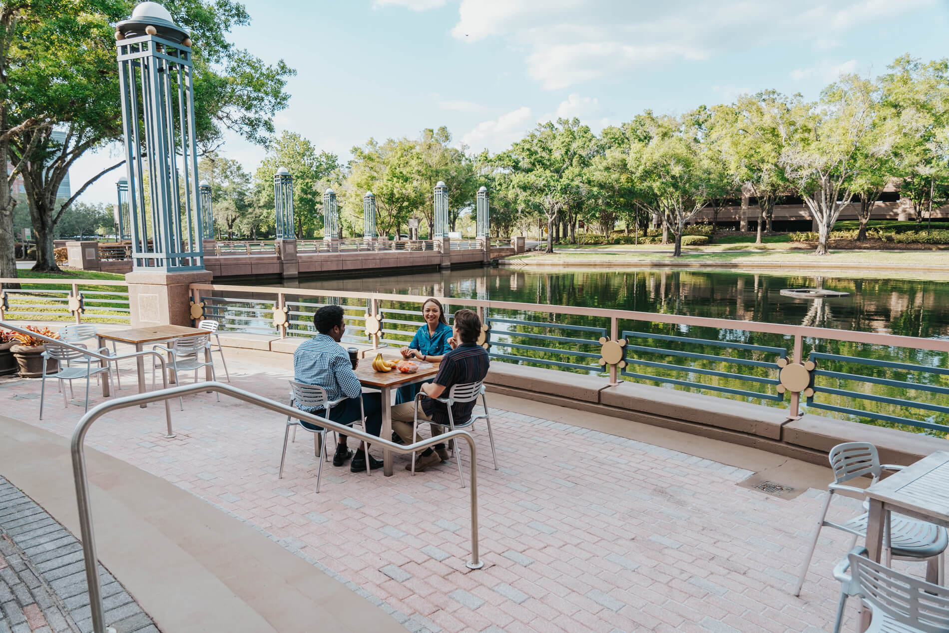 Arbors At Maitland three people sit at a patio table