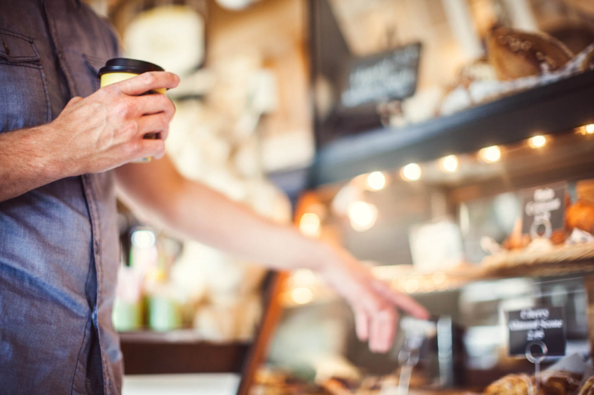 Person in cafe looking at food display