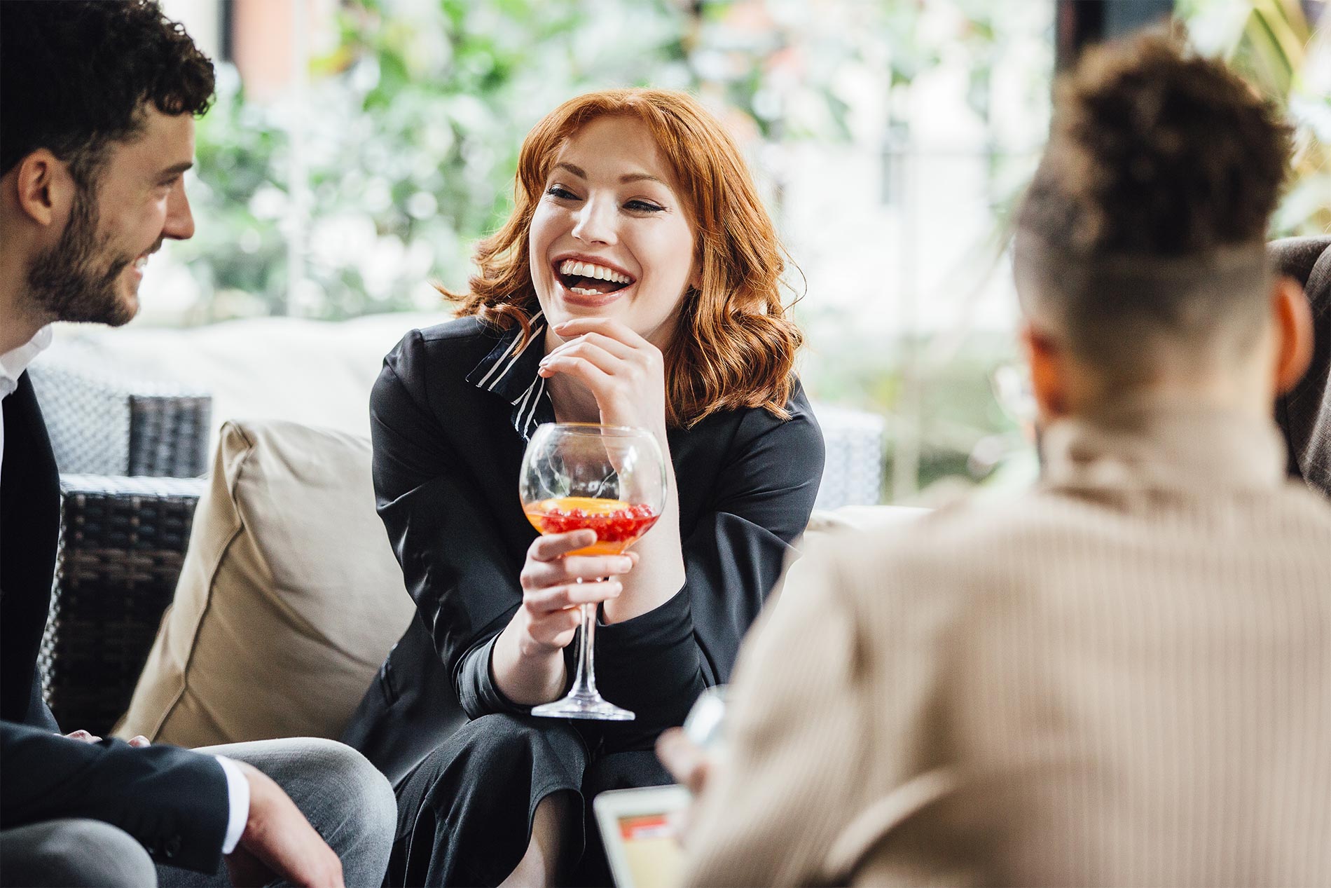 Happy woman laughing with friends