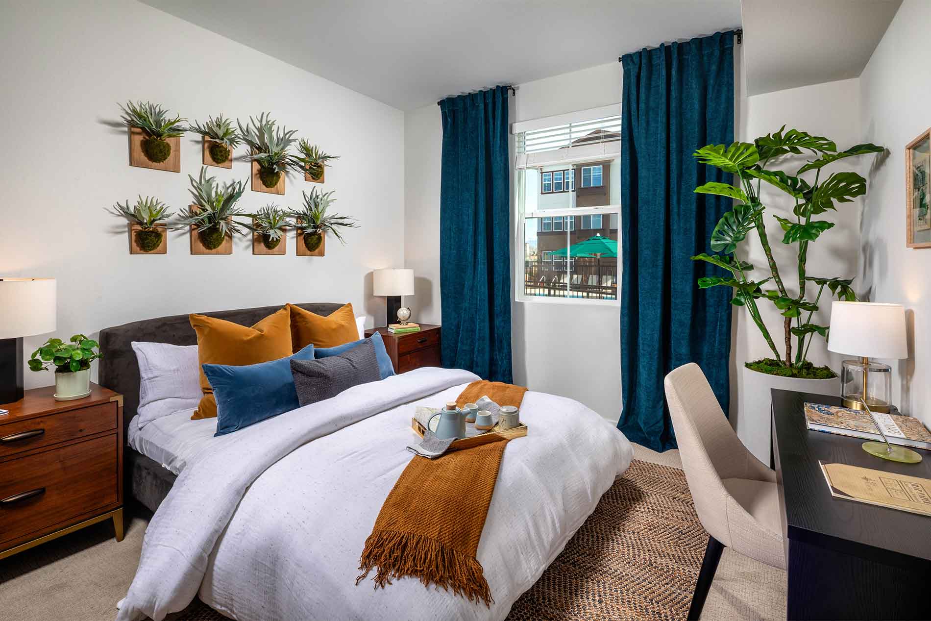 Comfortable primary bedroom inside an Avena apartment in Menifee, CA