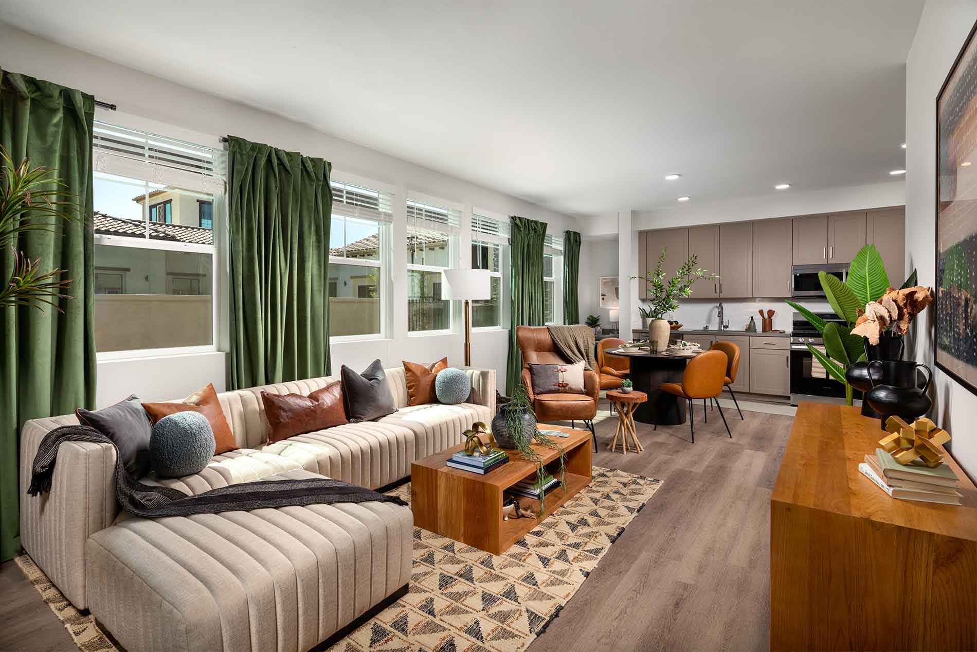 Spacious living room with wood plank flooring at Avena in Menifee, CA