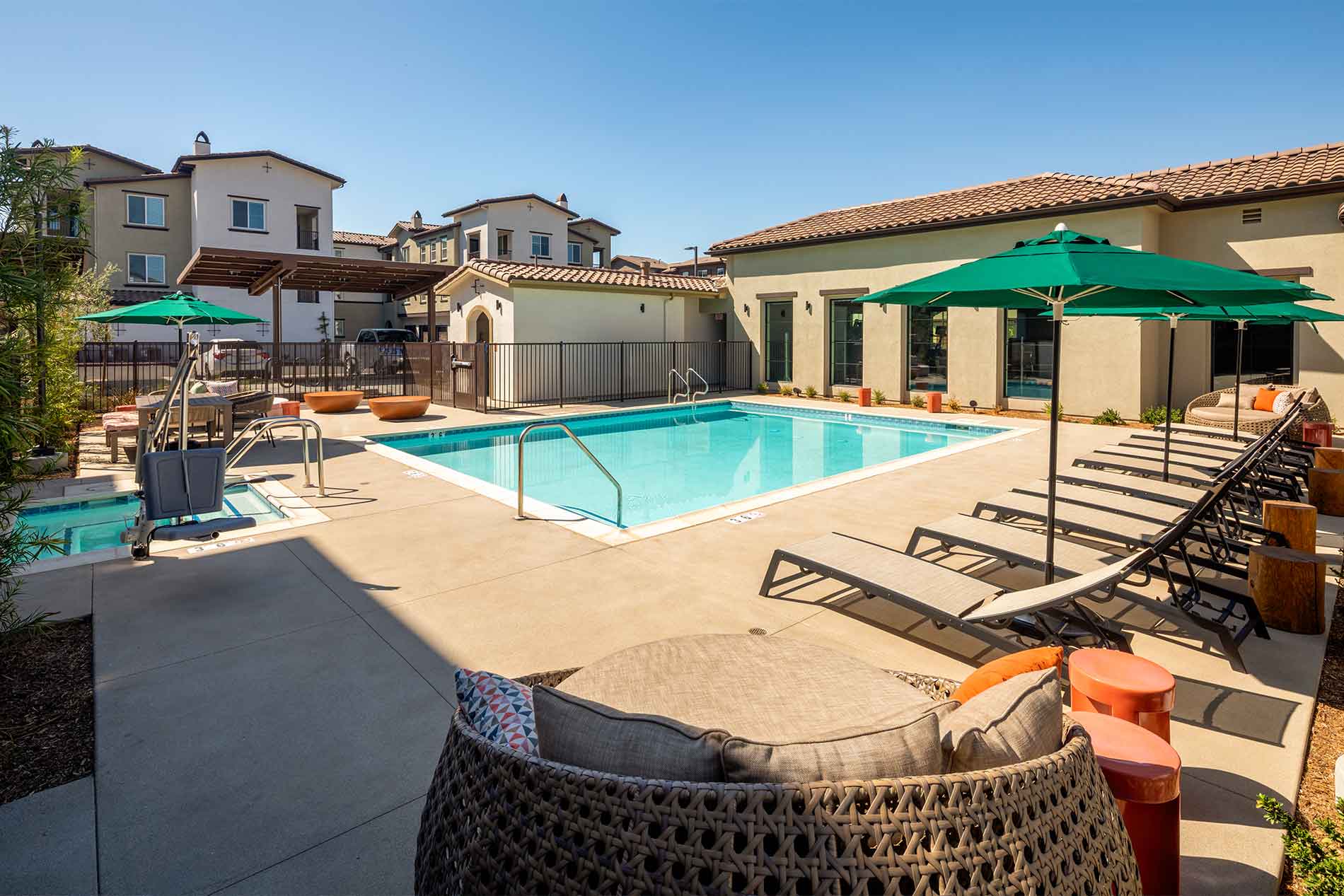 Swimming pool with lounge seating at Avena apartments in Menifee, CA