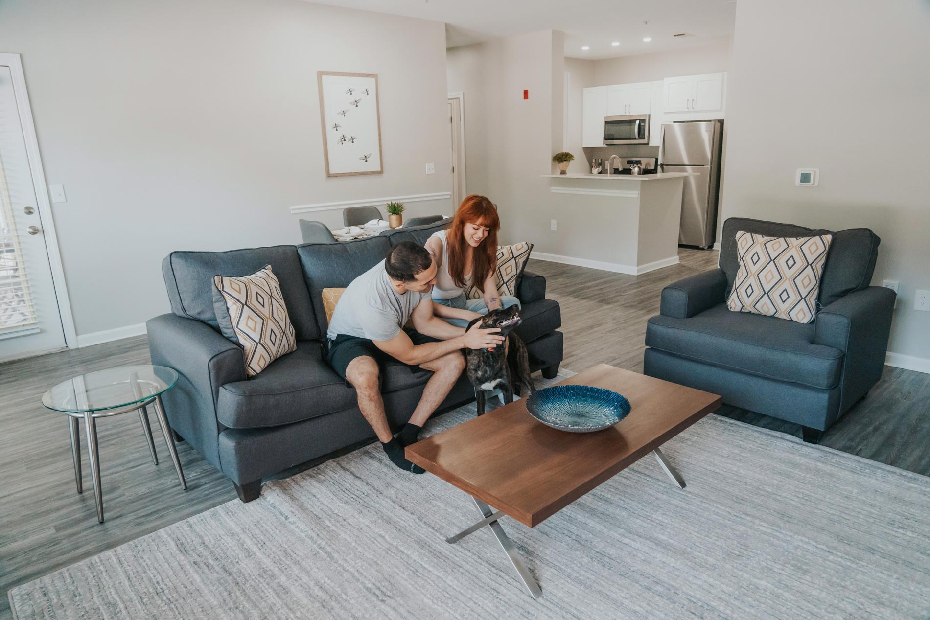 Bradlee Danvers man and woman pet dog in living room