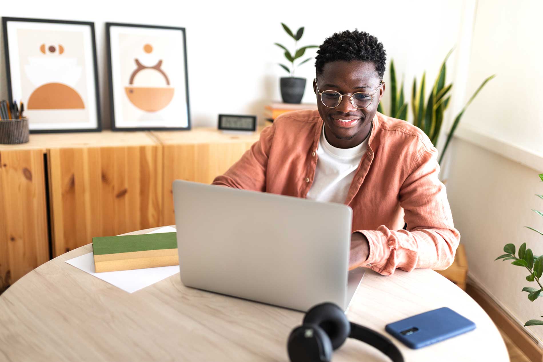 Man sitting at table with laptop