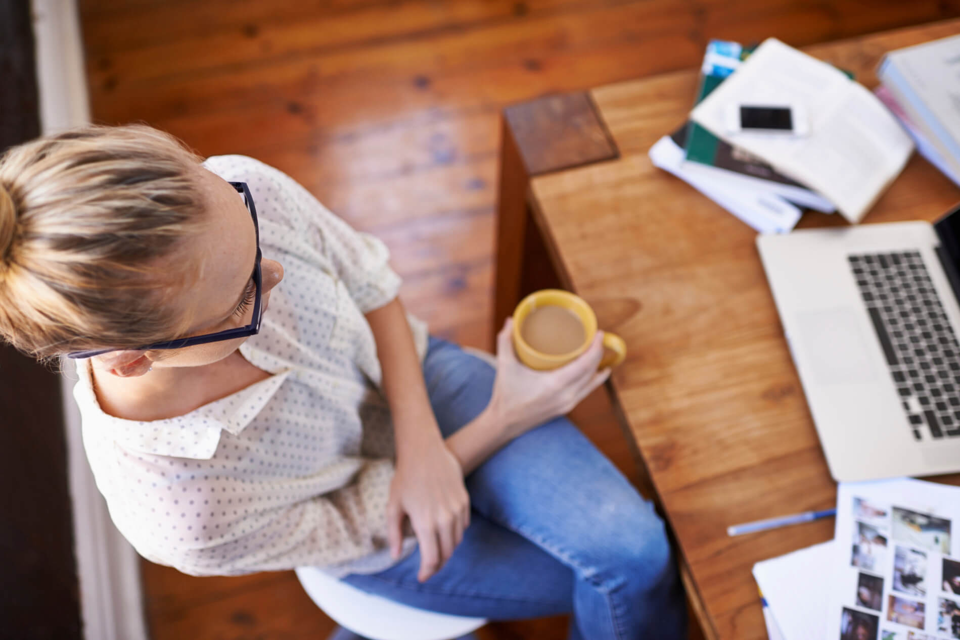 Girl sitting at computer with coffee