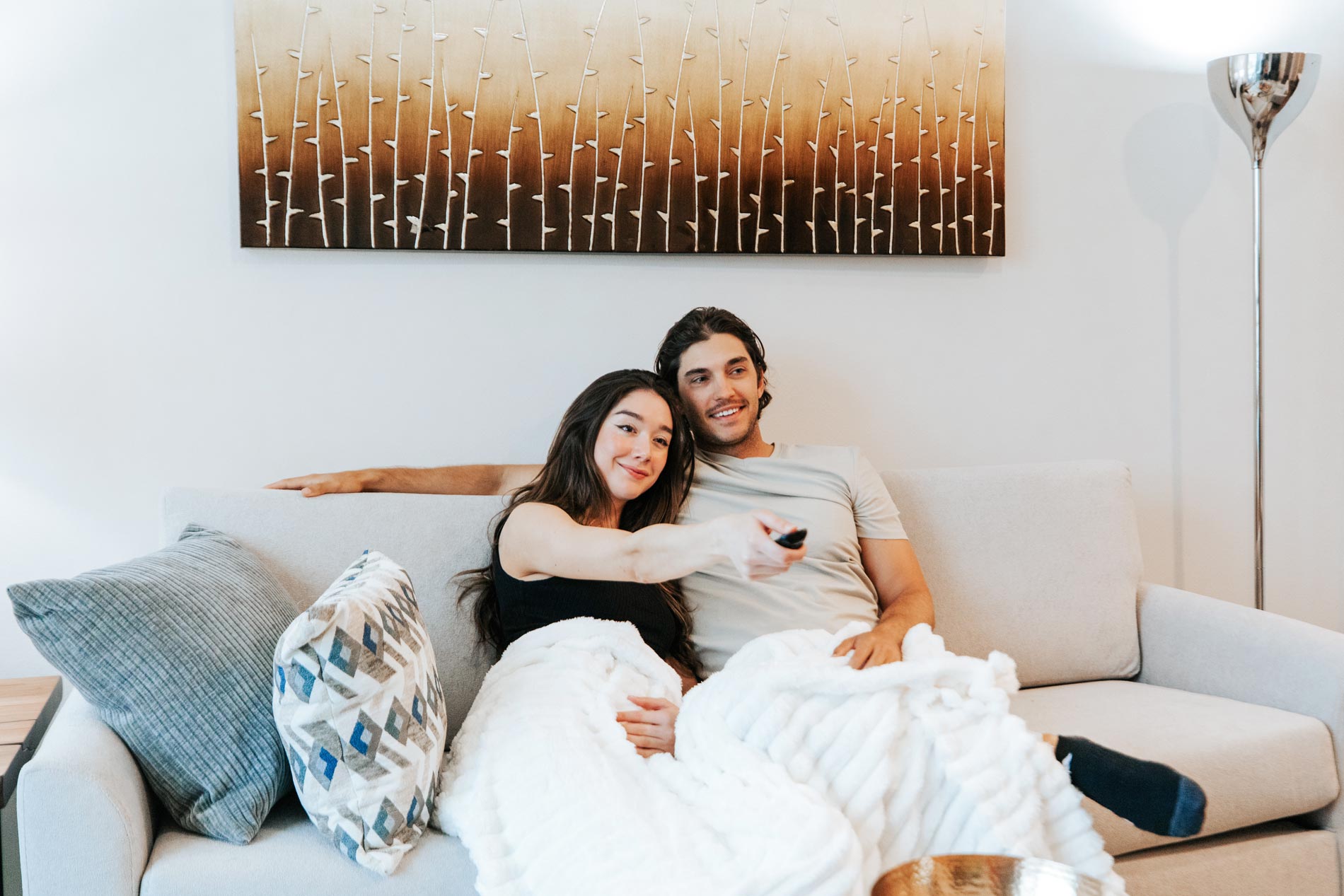 Central Square couple sits on couch
