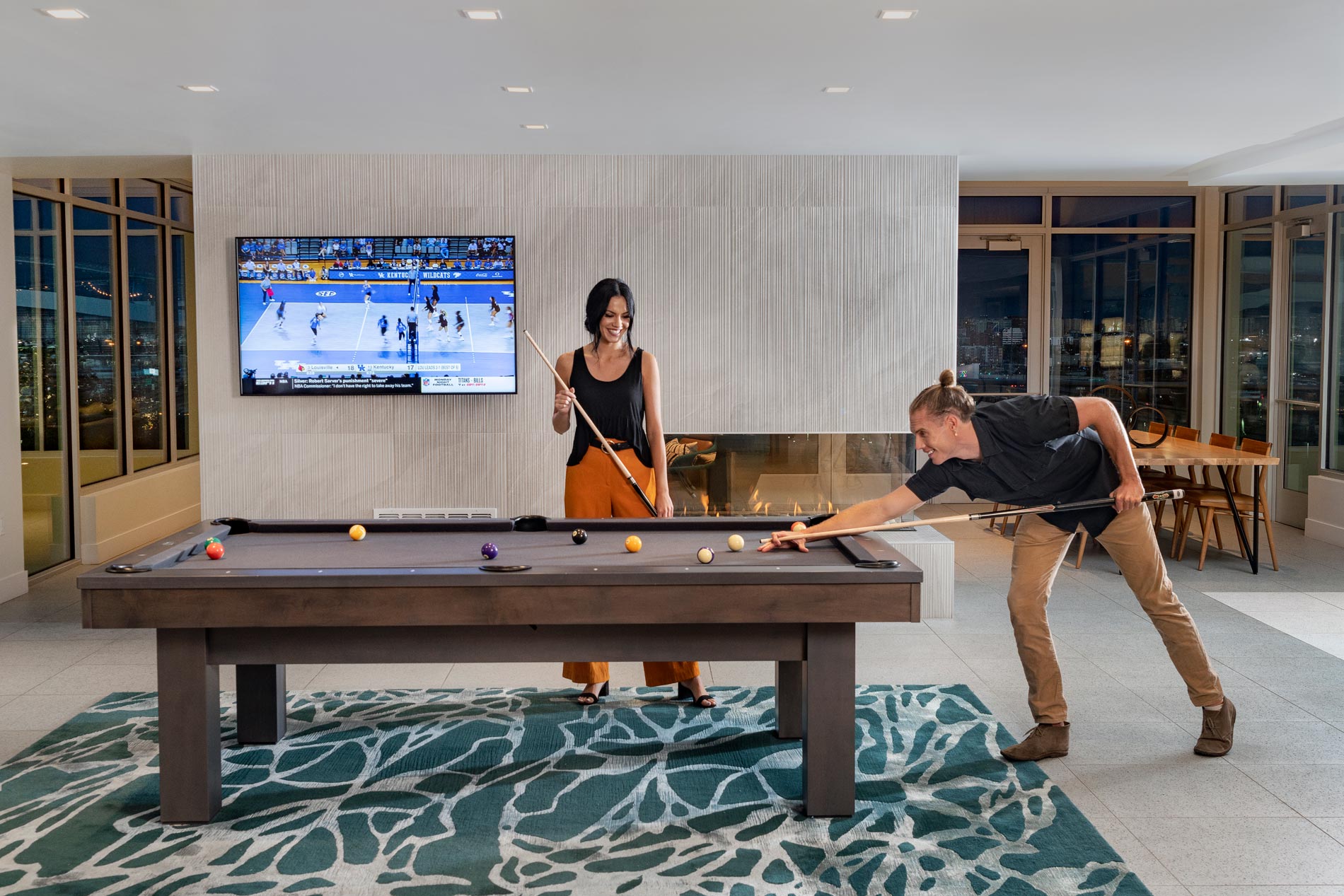 Cirrus Apartments Woman and Man Play Pool