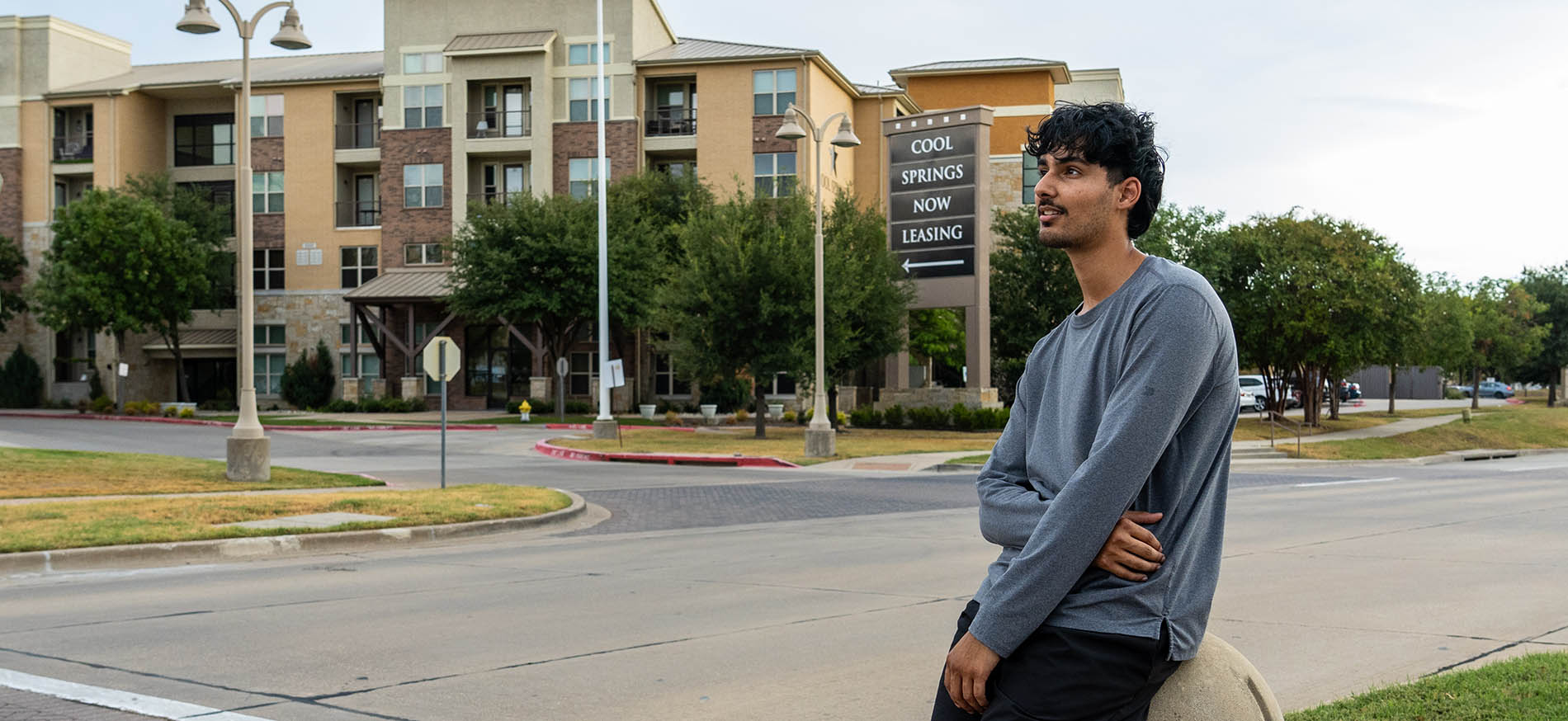 Man standing in street in front of Cool Springs