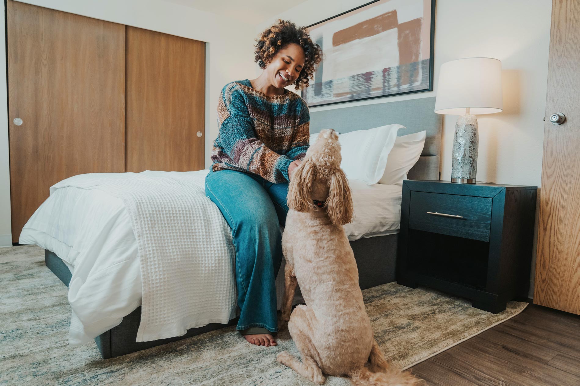 Crown Pointe woman with dog in bedroom