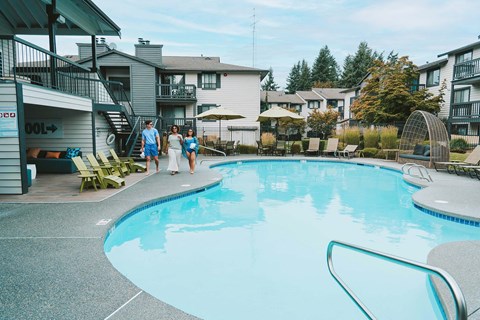 Crown Pointe three people walk by pool Crown Pointe three people walk by pool