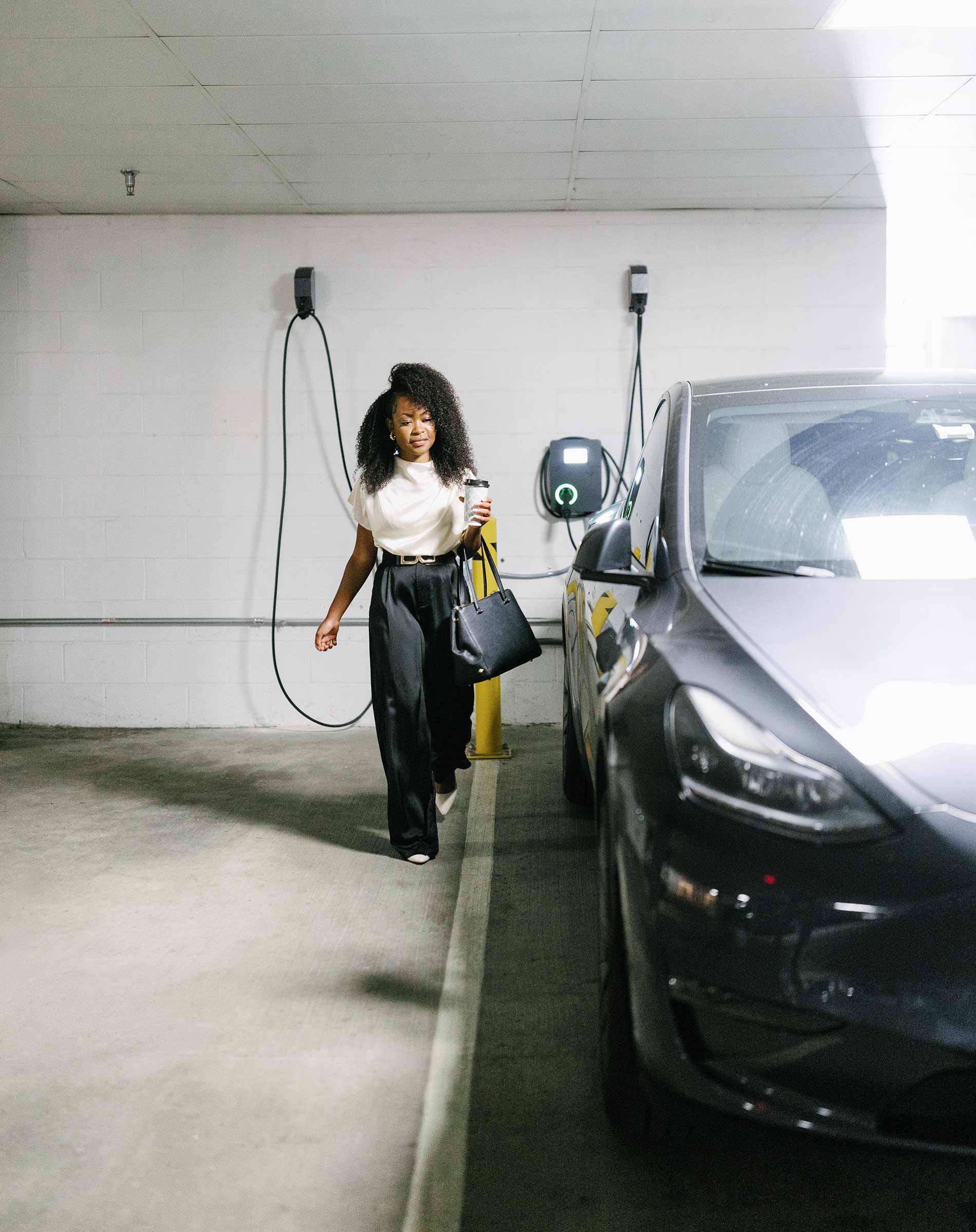 Domain Brewers Hill woman walks to car by EV charger