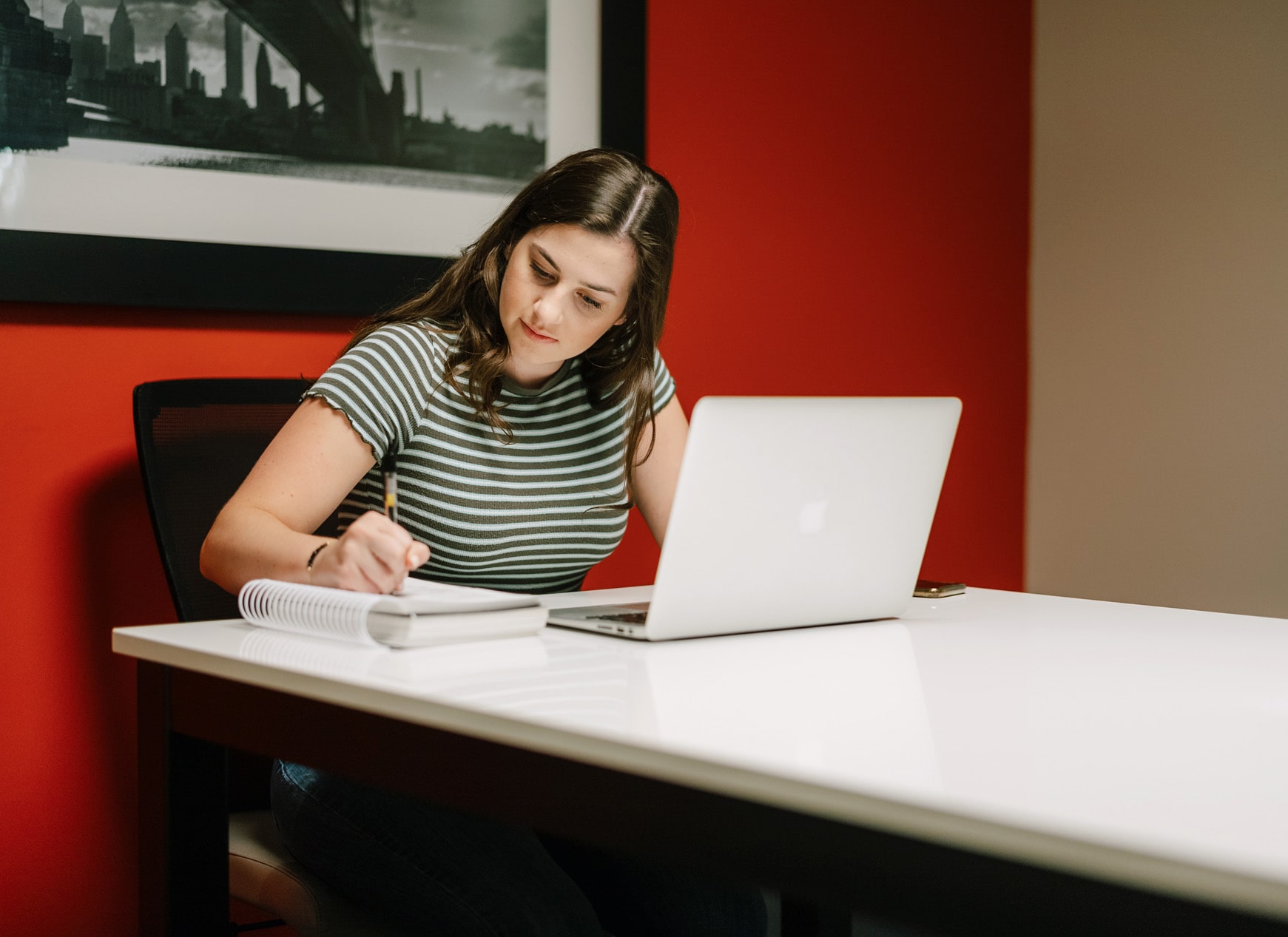 Domus Apartments woman working on laptop in business center