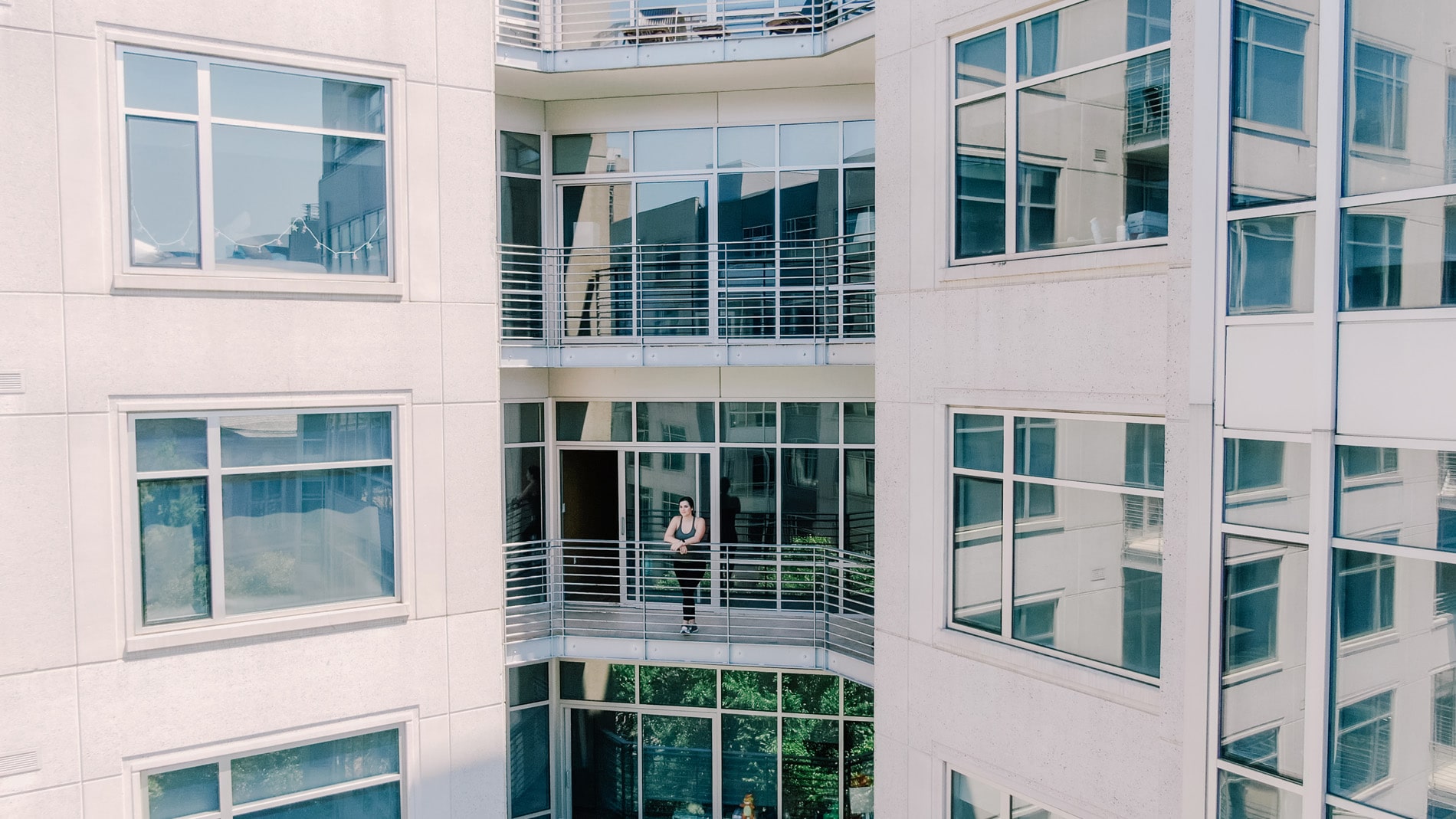 Domus Apartments woman on patio