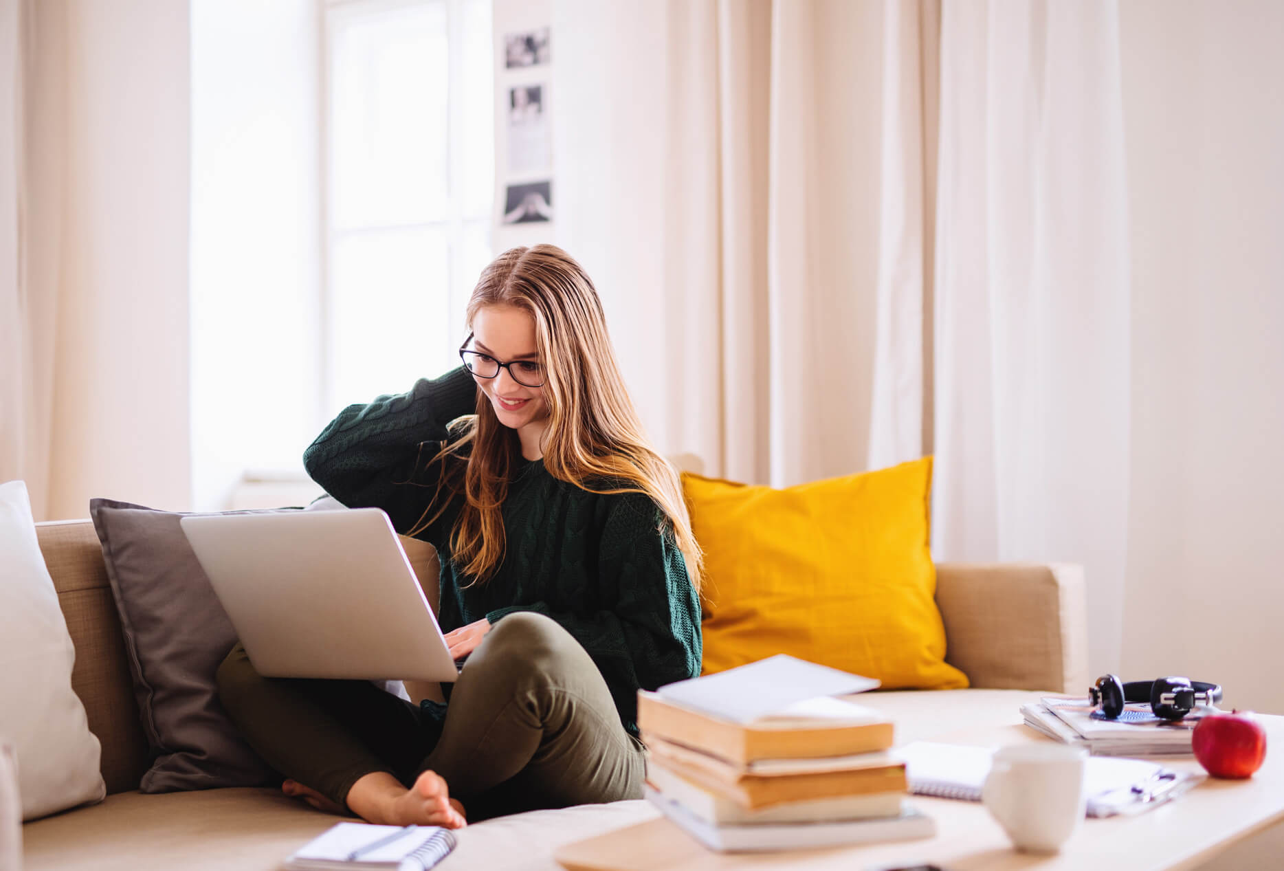 Woman working on laptop on couch