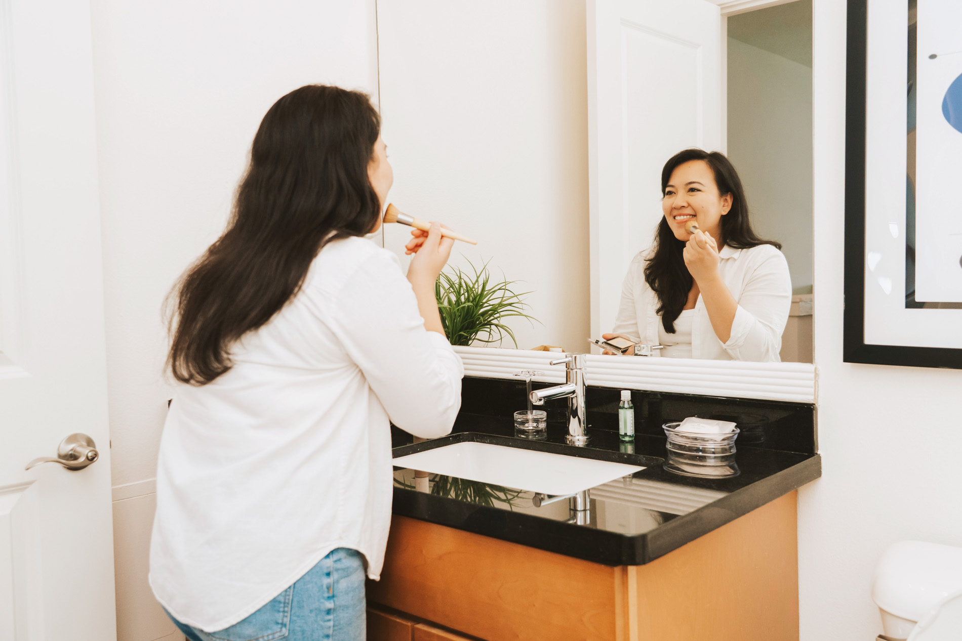 Edgewater woman gets ready in bathroom
