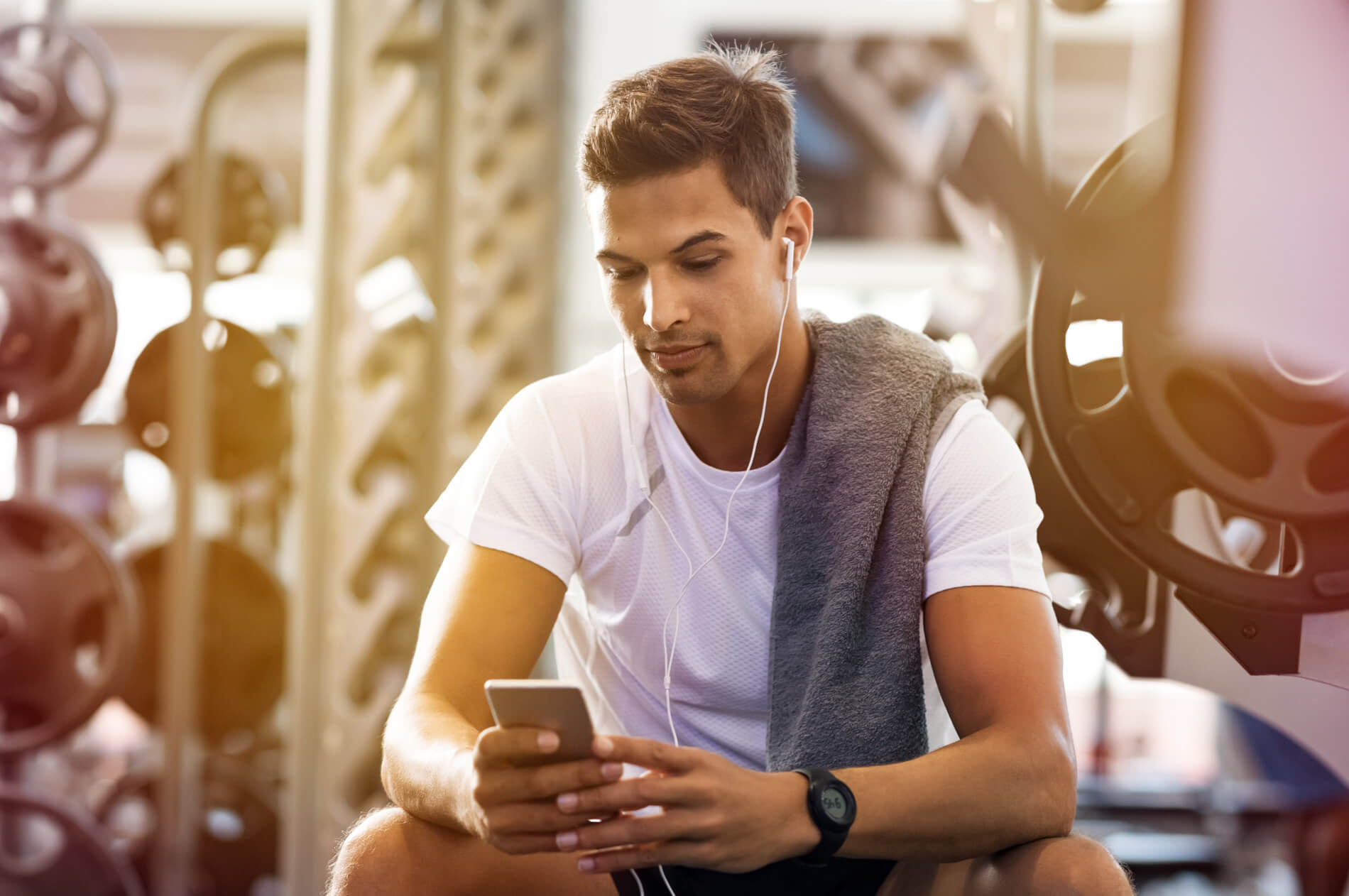 Man on his phone in the gym