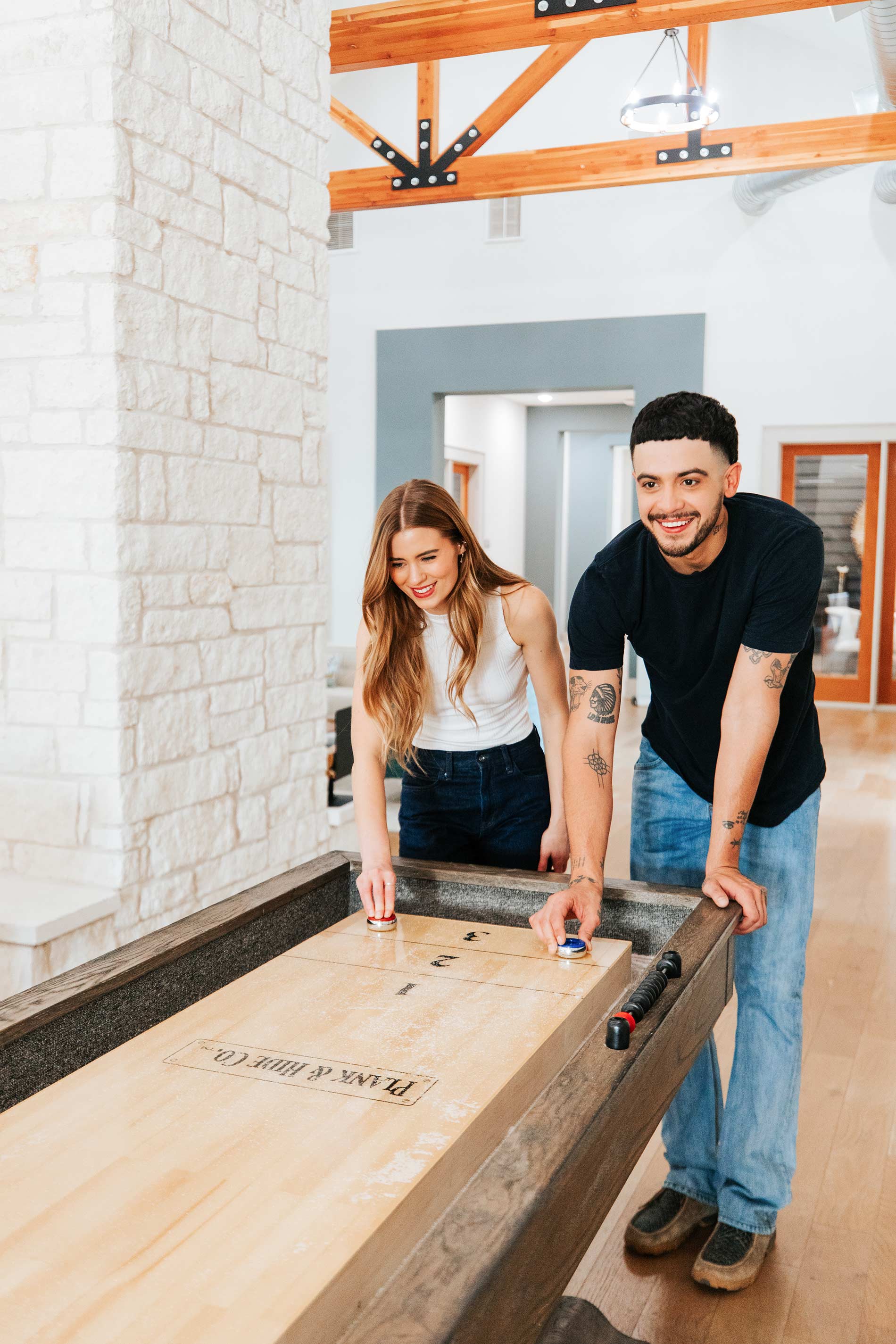 Estancia Villas woman and man play shuffle board