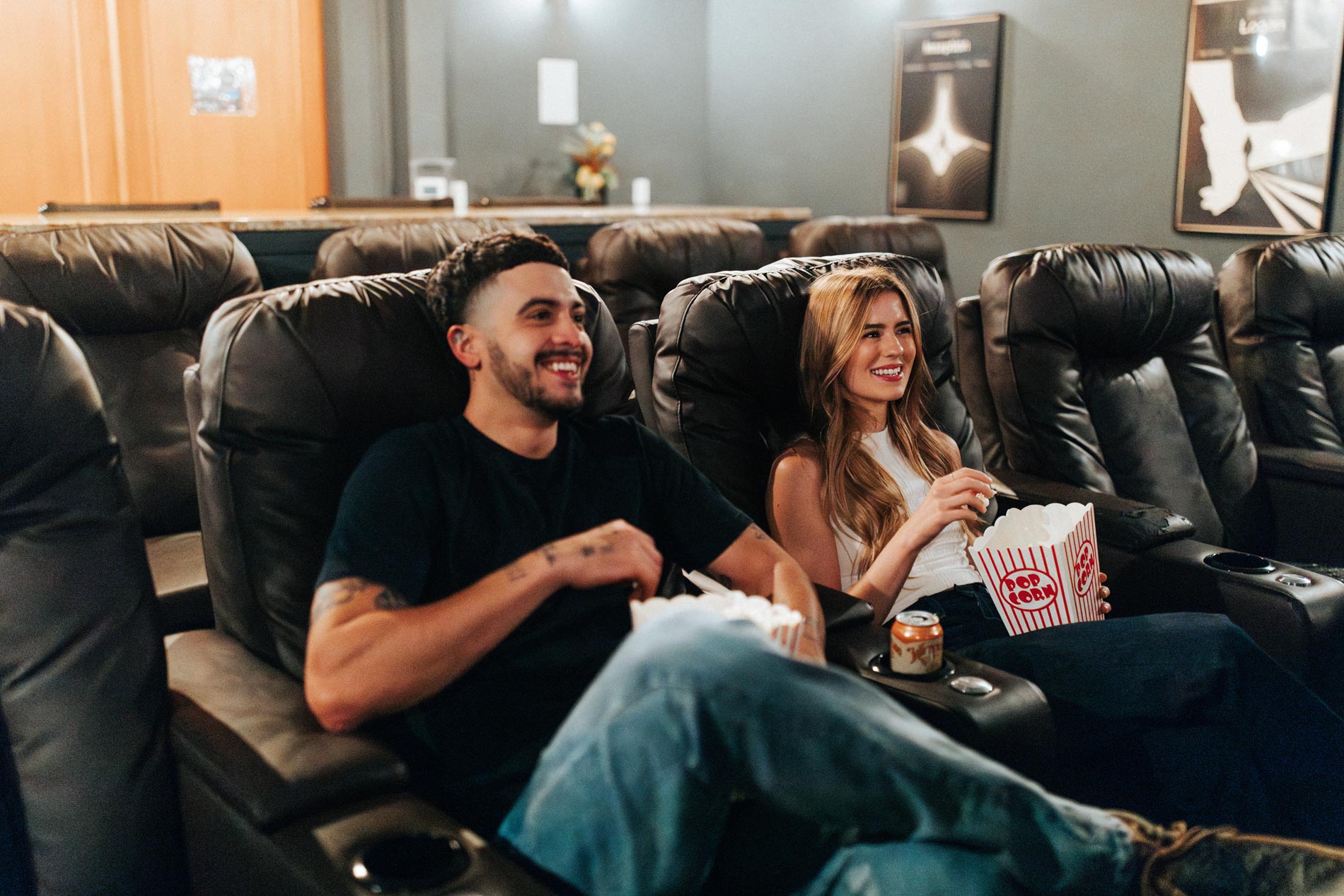 Estancia Villas man and woman watch a movie in theater