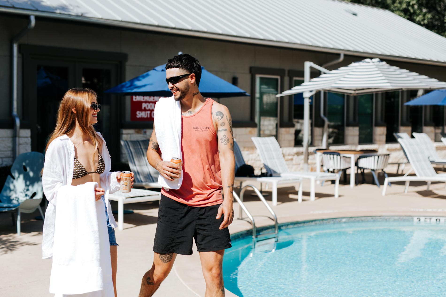 Estancia Villas man and woman stand by pool