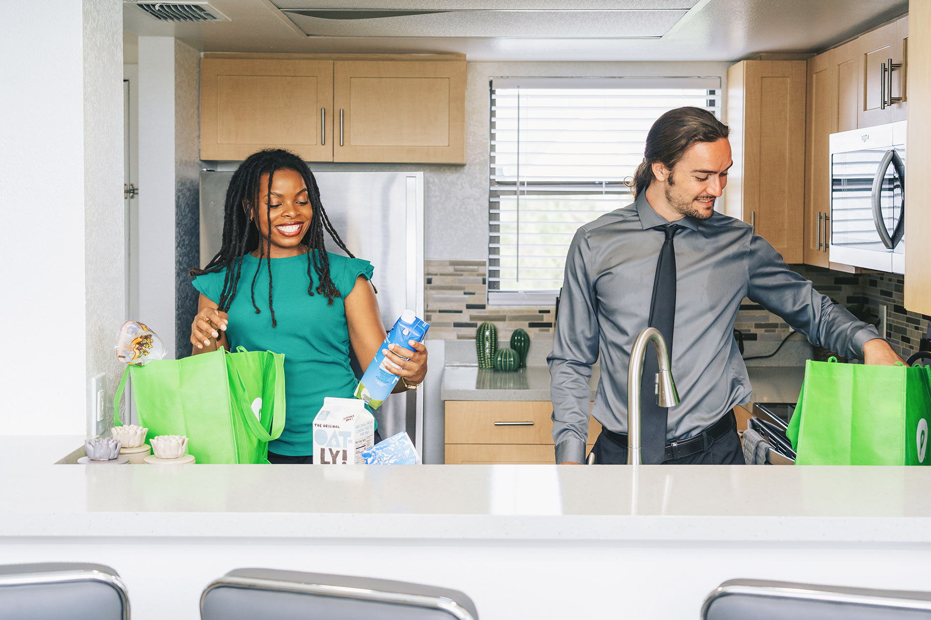 Inlet Bay man and woman unpack groceries in kitchen