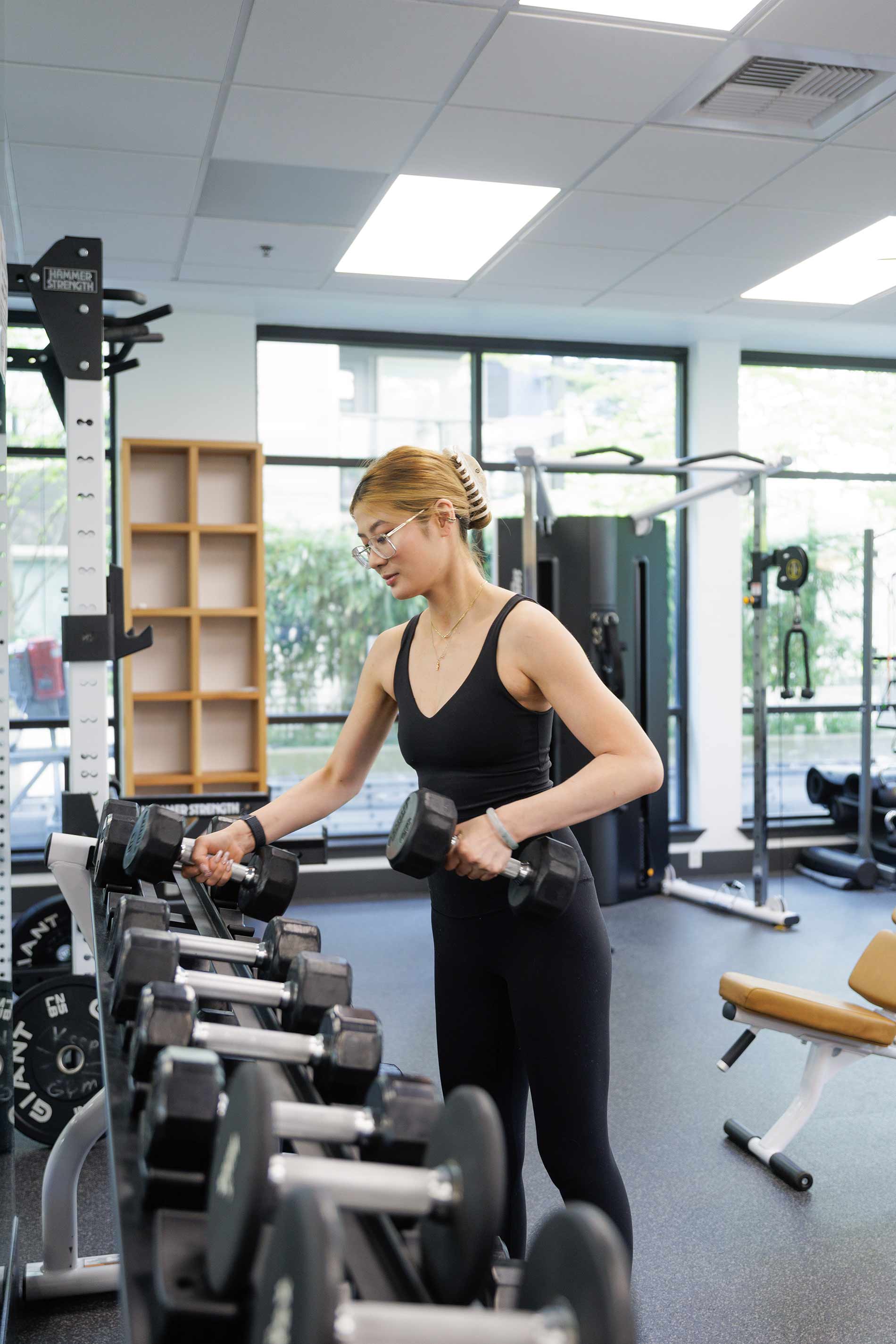Island Square woman grabs weights in fitness center