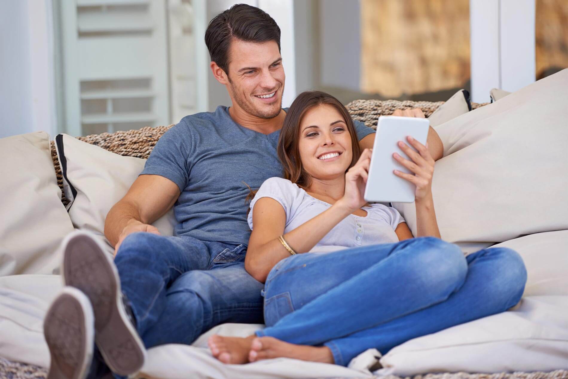 Happy couple lounging on the couch