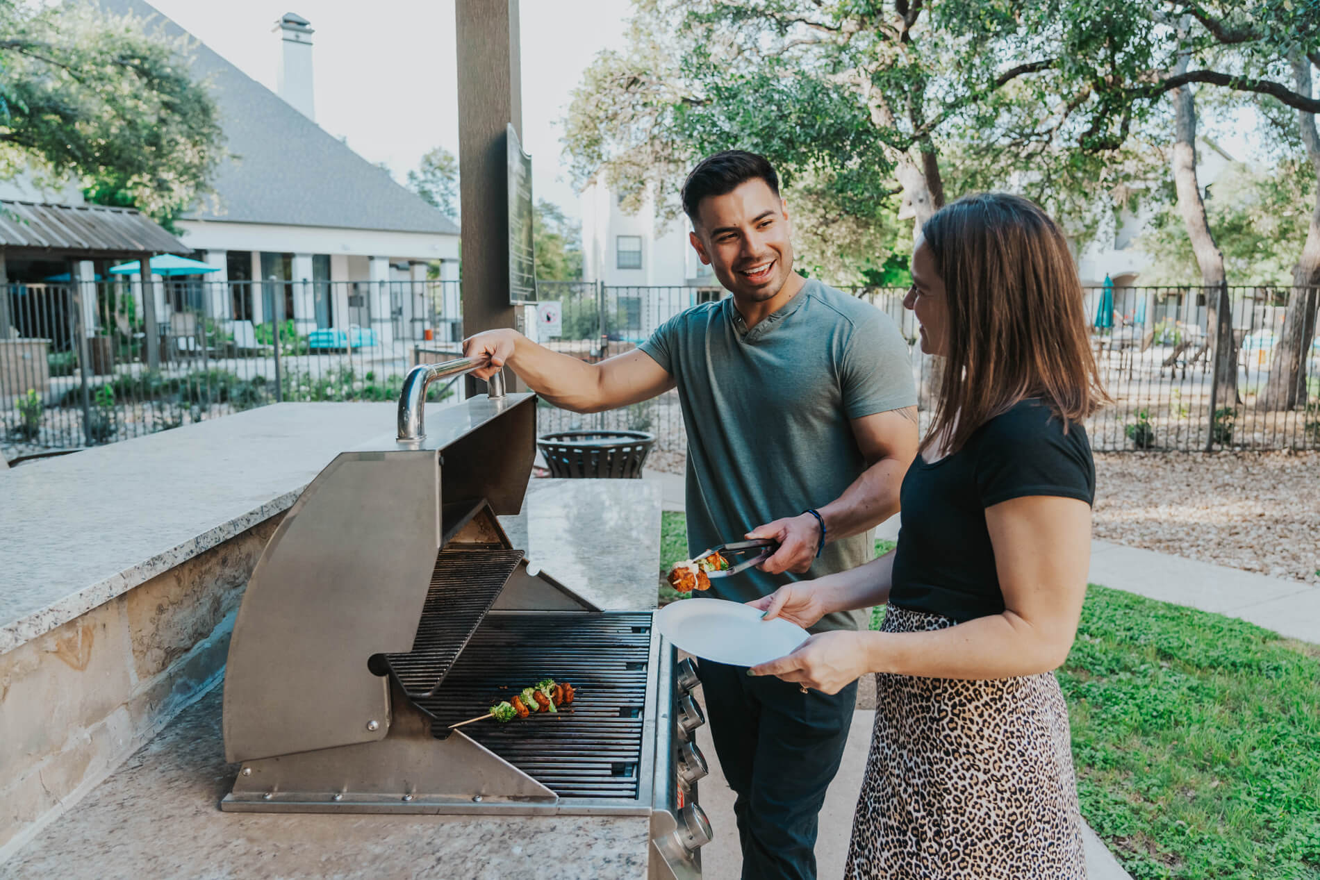 Lakeline Villas man and woman grill kebabs