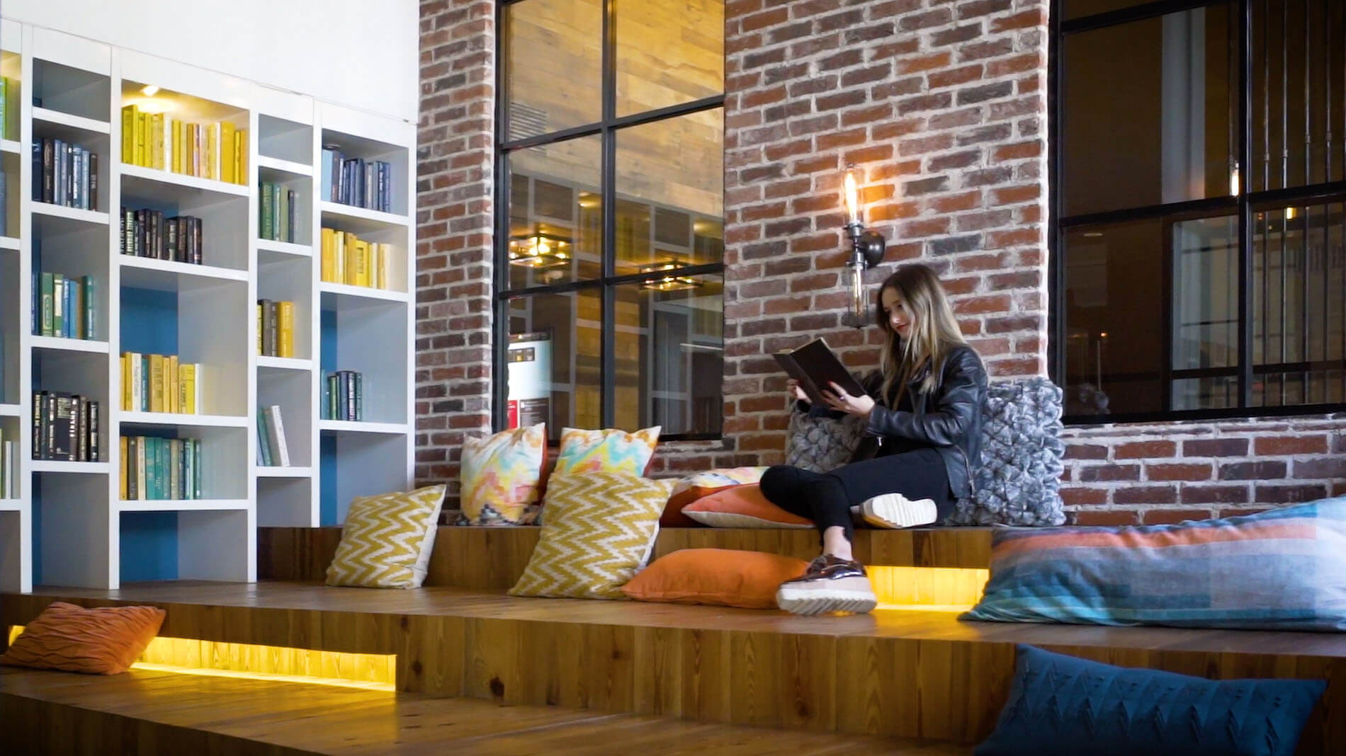 Woman reading in the Leonard Pointe clubroom