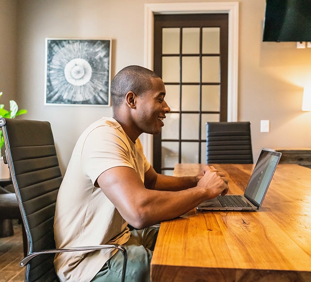 Man using laptop computer at table