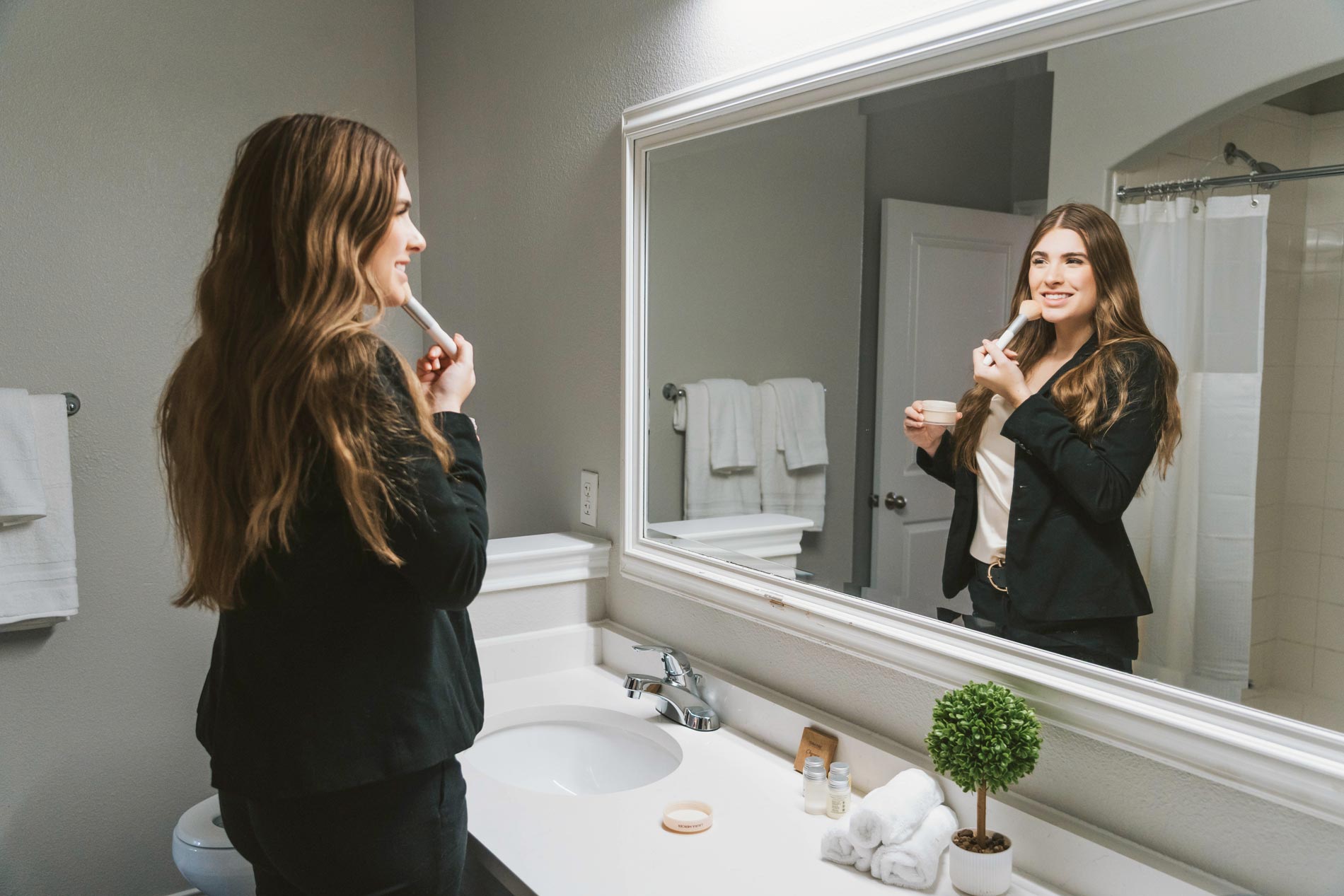 Ridge at Blue Hills woman gets ready in bathroom