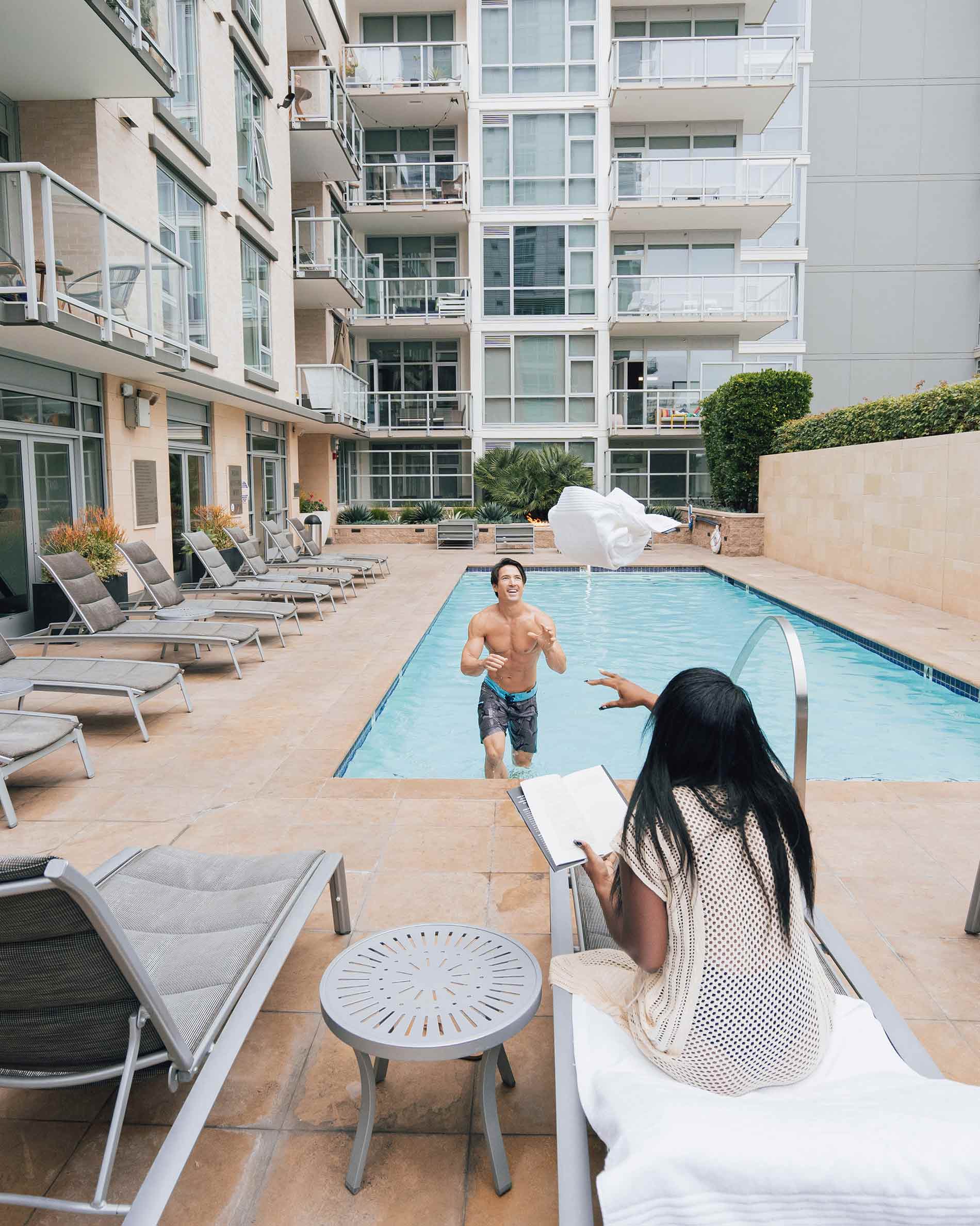 Strata woman throws man a towel at pool