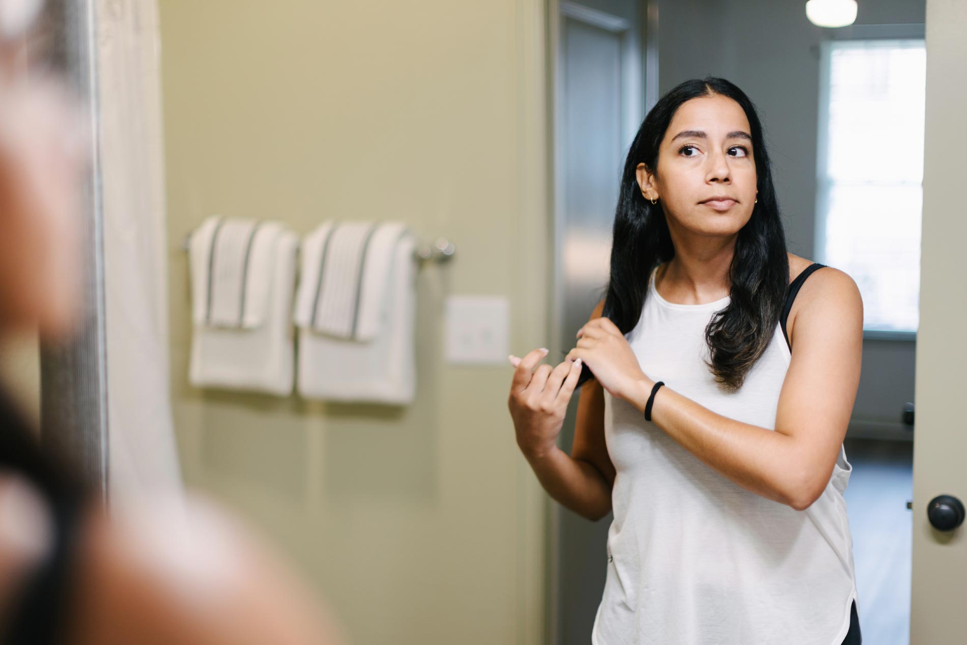 The Enclave woman gets ready in bathroom