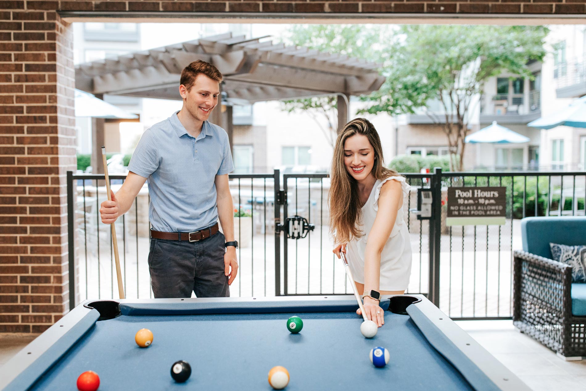 Flats At Palisades couple plays a game of pool