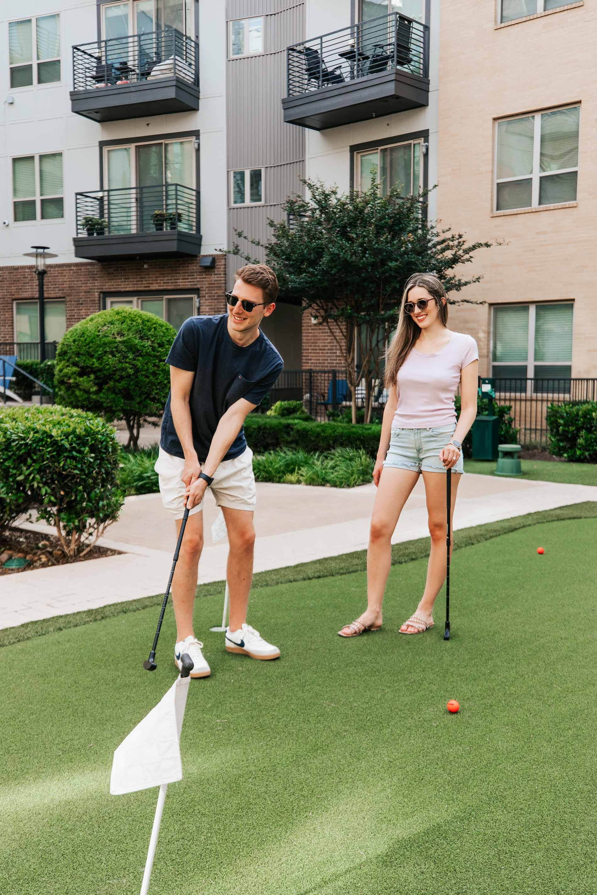Flats At Palisades couple plays on putting green