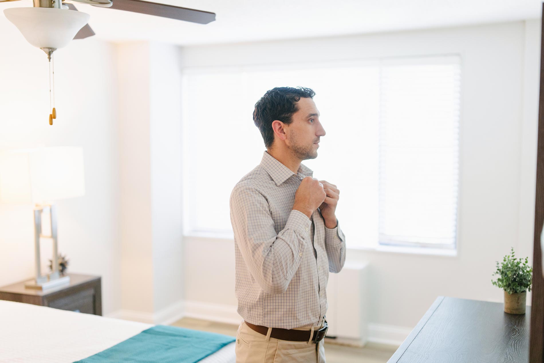 Whitmore apartments man gets ready in bedroom