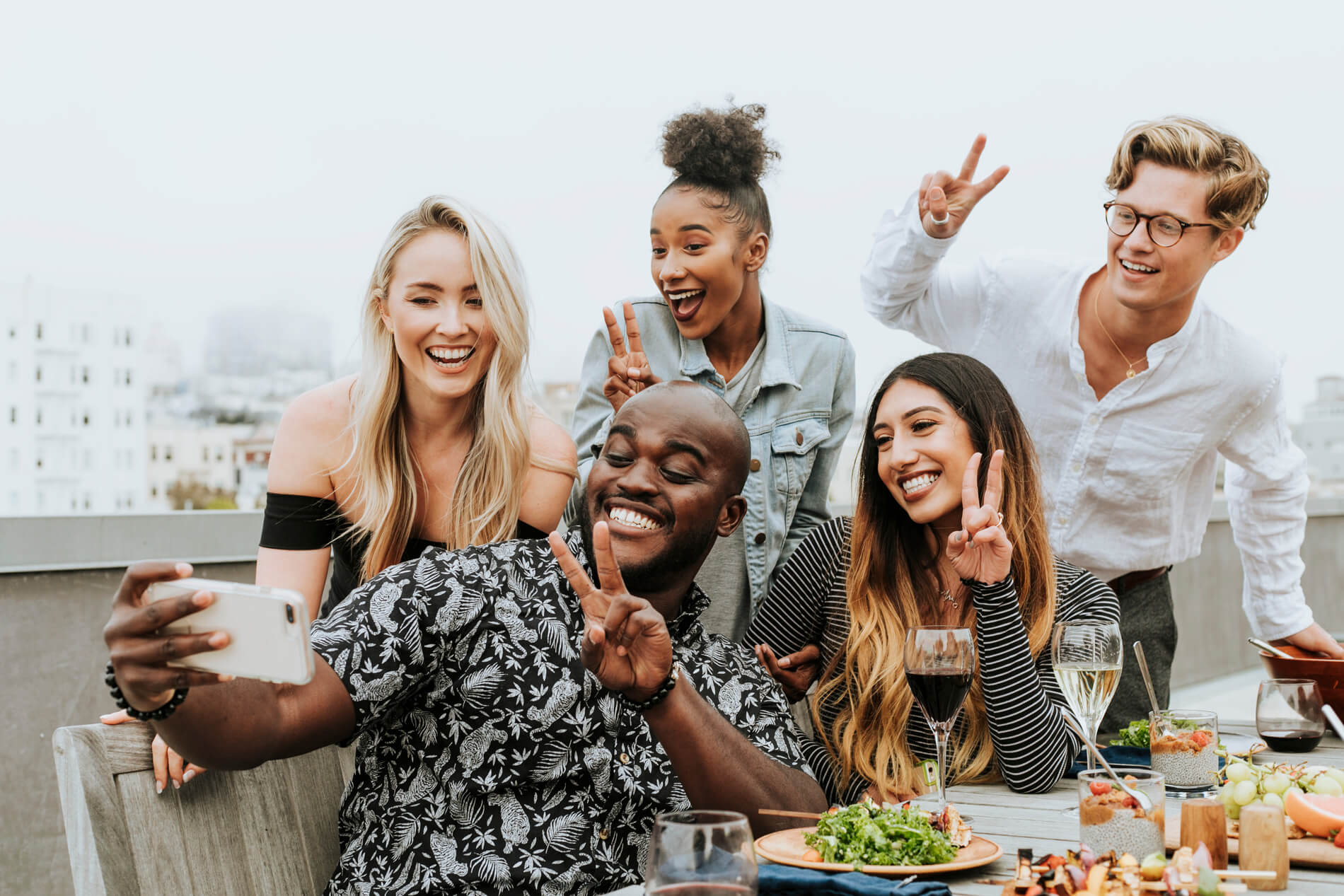 Friends laughing taking a selfie outside