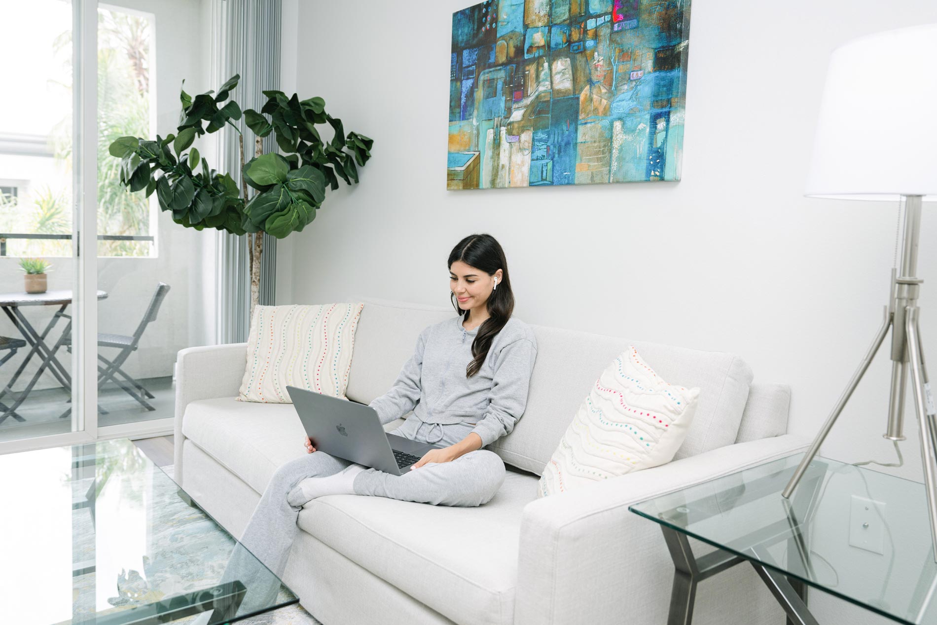 Tierra Del Rey woman works on laptop in living room