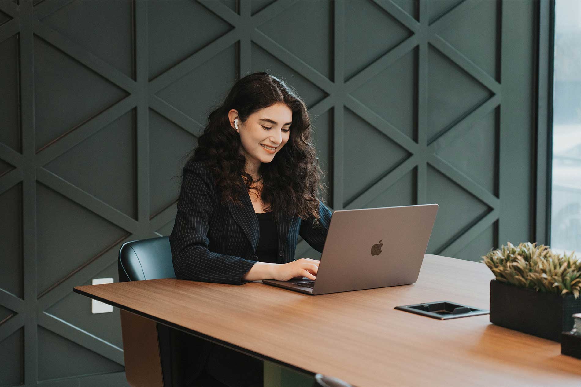 Young woman working on a laptop in a conference room